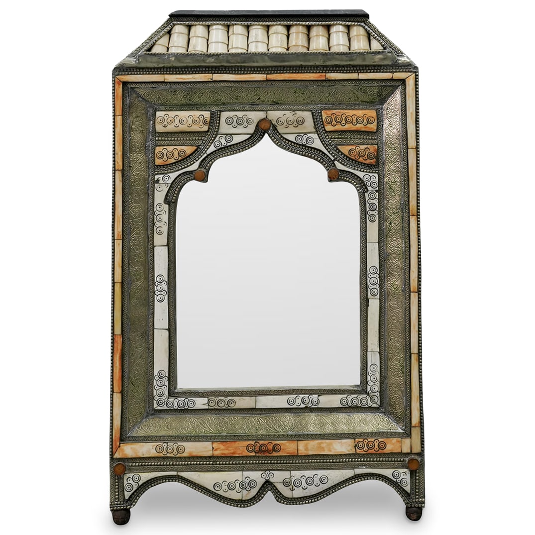 Moroccan Bone and Silvered Metal Inlaid Mirror: Moroccan Bone and Silvered Metal Inlaid Mirror20th century, MoroccoA Moroccan bone inlaid mirror with silvered metal paneling featuring ornate floral decorative engraving. Arched frame around mirror w