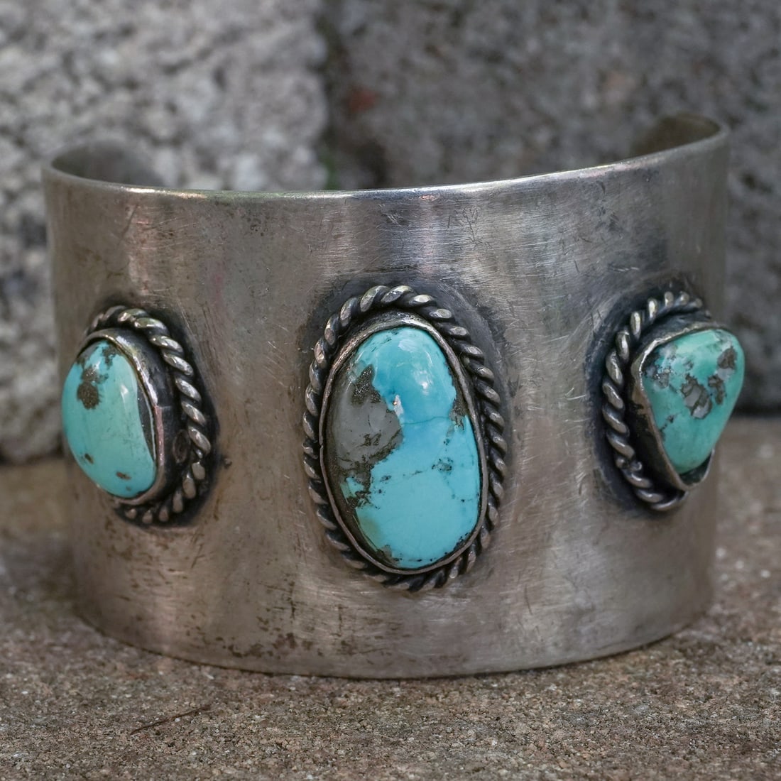 Vintage Navajo Sterling Silver & Turquoise Cuff: Vintage Navajo Sterling Silver & Turquoise CuffCirca: 1970s–1980s, USA.Vintage sterling silver cuff set with three natural turquoise cabochons, each framed in hand-twisted rope silver. Center stone