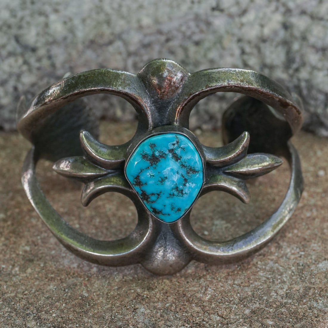 Vintage Navajo Sterling Silver & Turquoise Bracelet: Vintage Navajo Sterling Silver & Turquoise BraceletCirca 1970sVintage Navajo sterling silver bracelet featuring a large freeform turquoise cabochon measuring approximately 28mm x 22mm. The stone sits