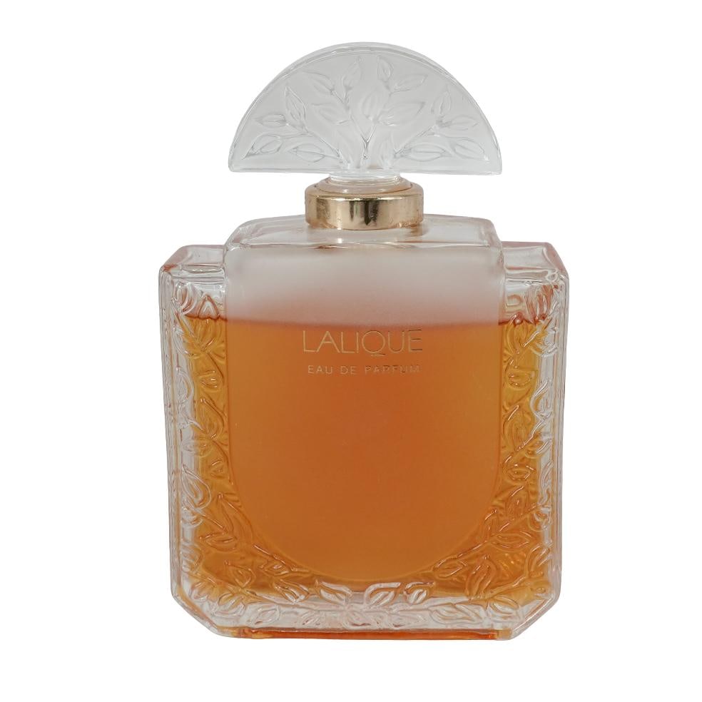 Lalique Perfume Bottle With Original Perfume: Lalique Perfume Bottle With Original Perfume20th Cent., FranceLalique crystal perfume bottle featuring a frosted glass stopper molded with a stylized leaf motif. The bottle retains part of its origina