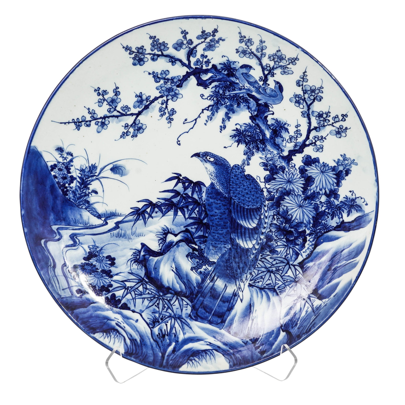 Large Japanese Arita Blue & White Porcelain Charger: Large= Japanese Arita Blue & White Porcelain Charger19th century, JapaneseLarge charger, It features a detailed, hand-painted landscape scene in traditional blue and white style, depicting an eagle pe