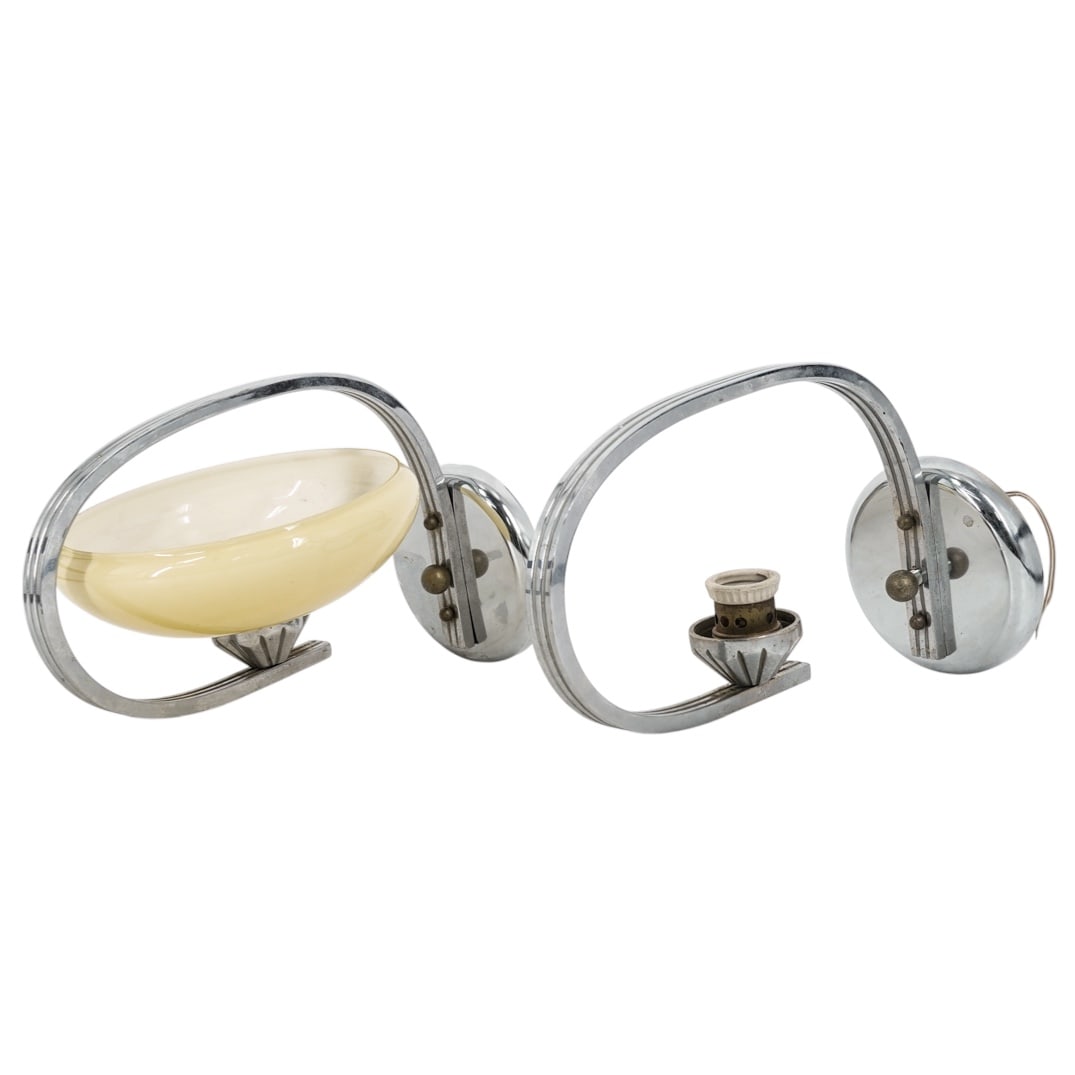 (2 pcs) Art Deco Streamline Wall Sconces: (2 pcs) Art Deco Streamline Wall Sconces1930s-1940sPair of vintage Art Deco chrome-plated wall sconces or bedside table lamps with yellow (or beige) cased glass shade.Depth 12.5" x L 6.5" x Mount cove