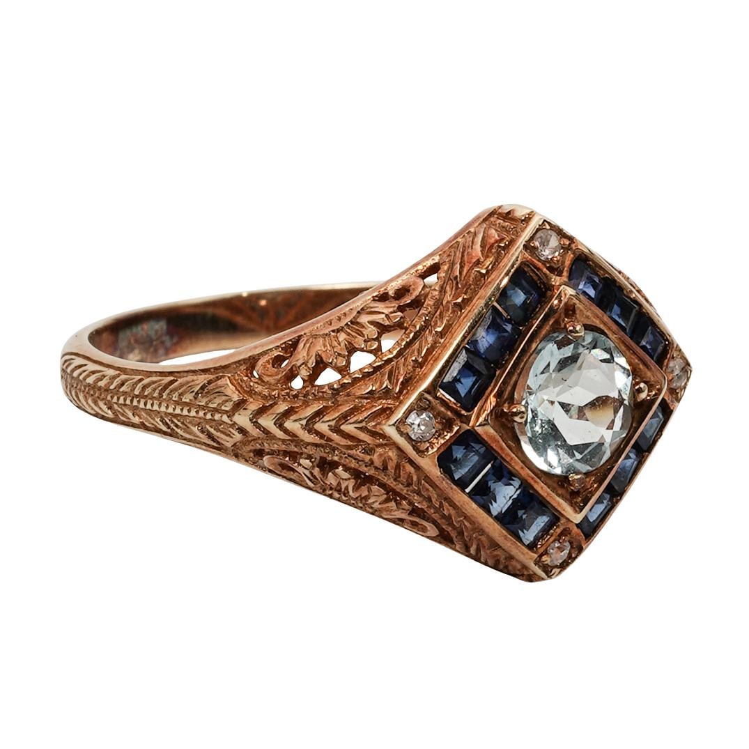 Vintage 14k Gold Sapphire & Aquamarine Ring: Vintage 14k Gold Sapphire & Aquamarine RingCirca Mid-20th centuryVintage 14k yellow gold ring set with a central round aquamarine weighing approximately 0.40 carats, flanked by two round blue sapphire