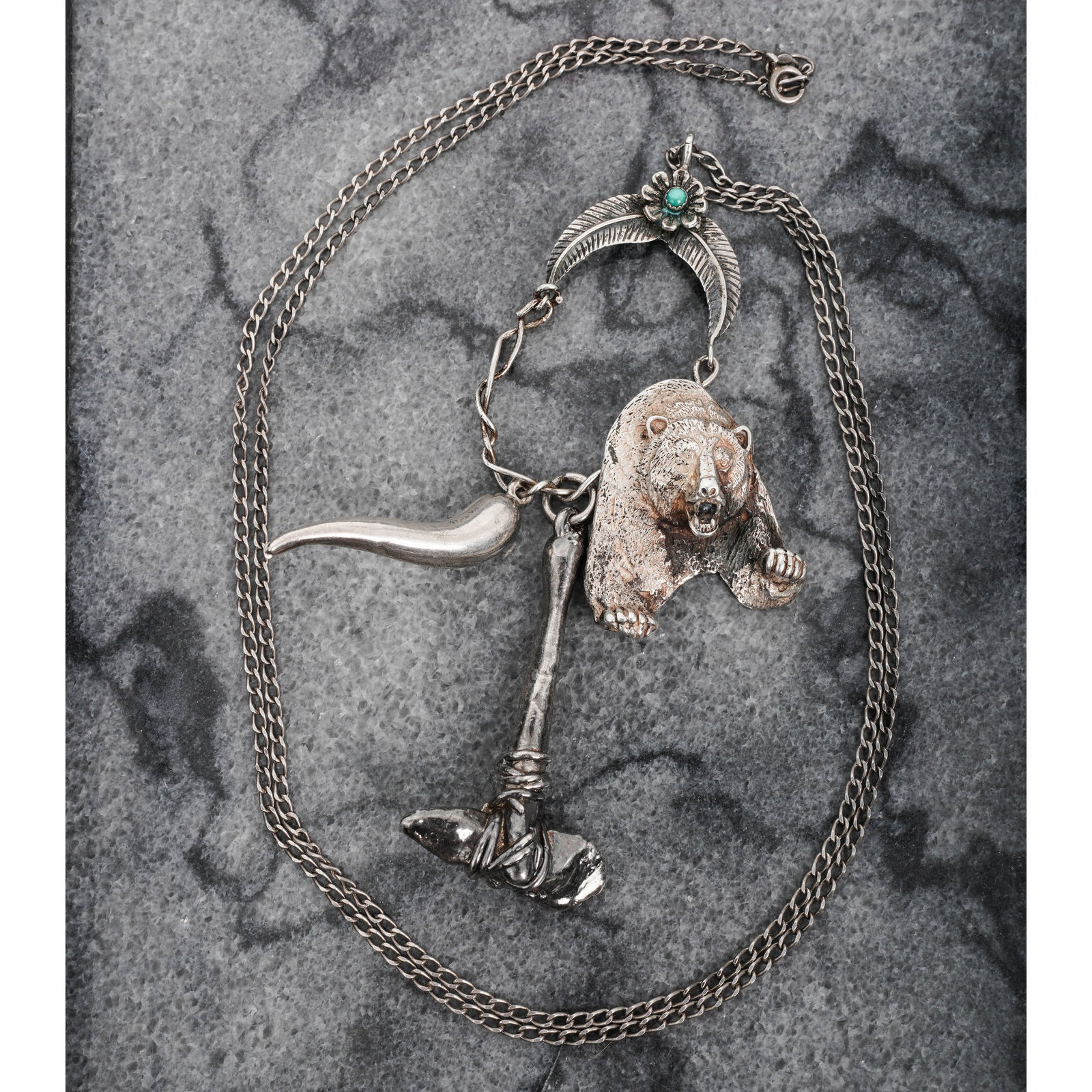 Vintage Navajo Sterling Silver & Turquoise Necklace: Vintage Navajo Sterling Silver & Turquoise NecklaceCirca 1960s-1970s, USAVintage Navajo sterling silver necklace composed of a figural bear element joined to a tomahawk-form pendant and a curved silve