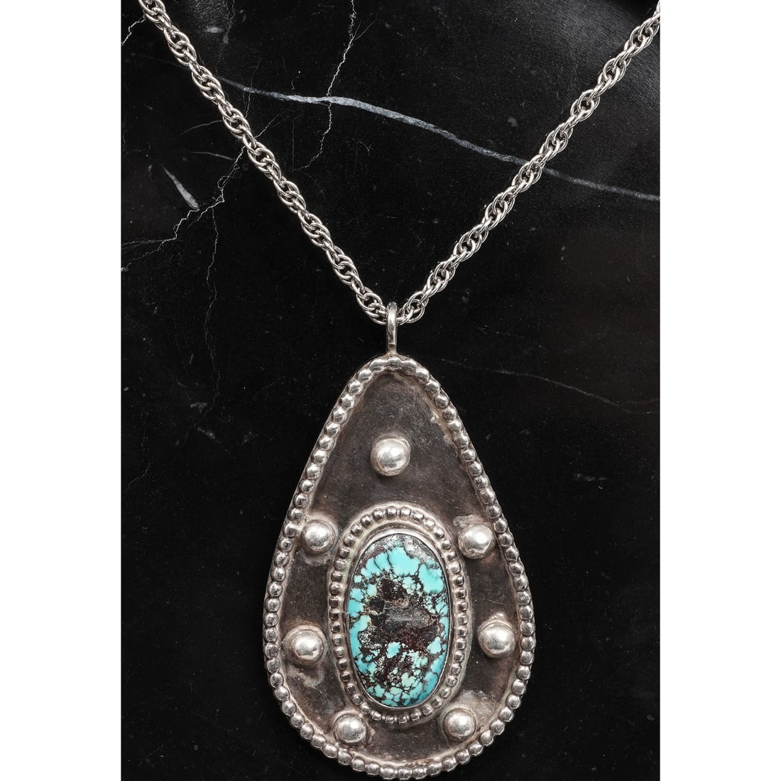 Vintage Navajo Sterling Silver & Turquoise Pendant Necklace Signed: Vintage Navajo Sterling Silver & Turquoise Pendant Necklace SignedCirca 1970s-1980s, USAVintage Navajo sterling silver pendant of elongated teardrop form, set with a single oval natural turquoise cabo