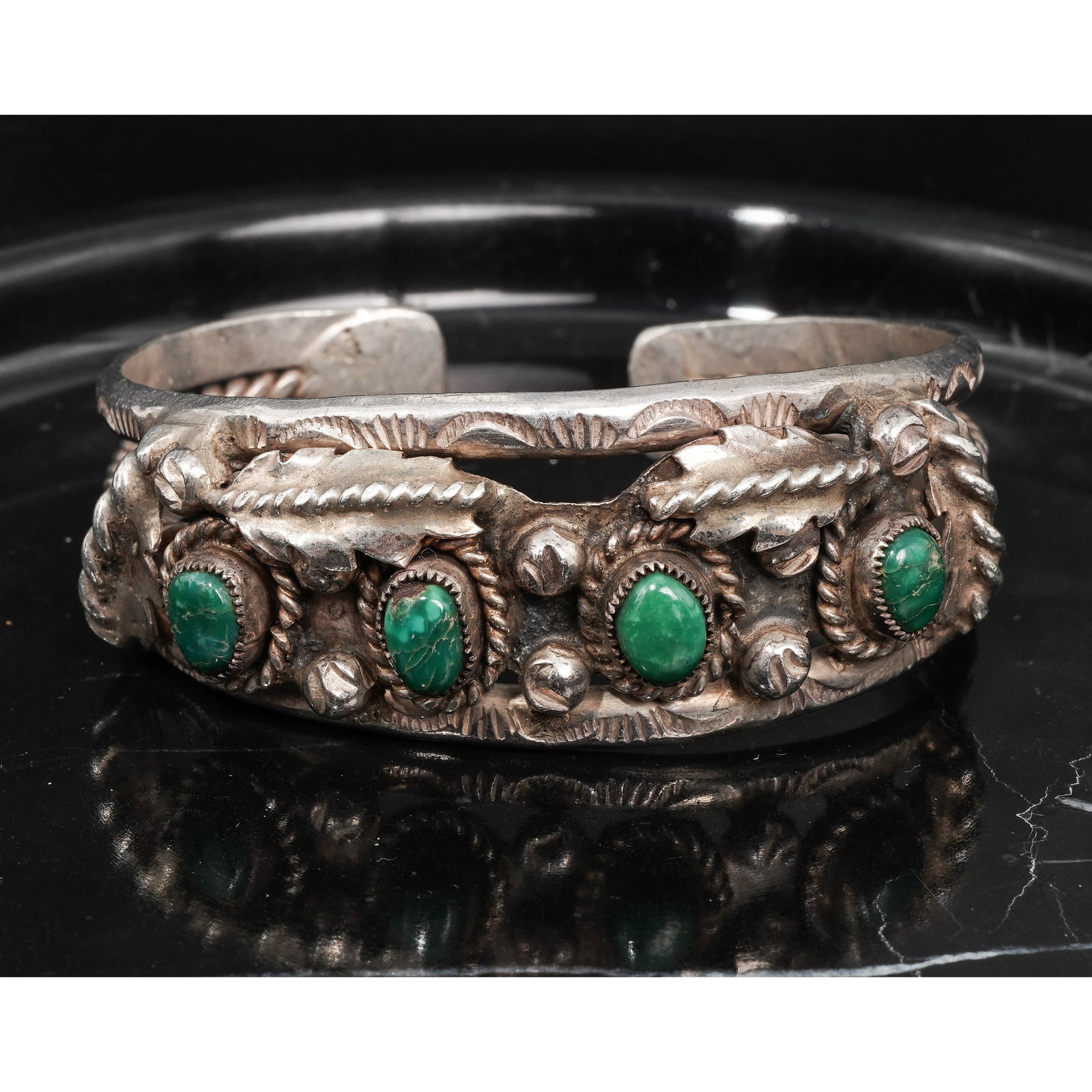 Vintage Navajo Sterling Silver & Turquoise Cuff Bracelet: Vintage Navajo Sterling Silver & Turquoise Cuff BraceletCirca 1970s-1980s, USAVintage Navajo sterling silver cuff bracelet set with four oval green turquoise cabochons, each measuring approximately 7