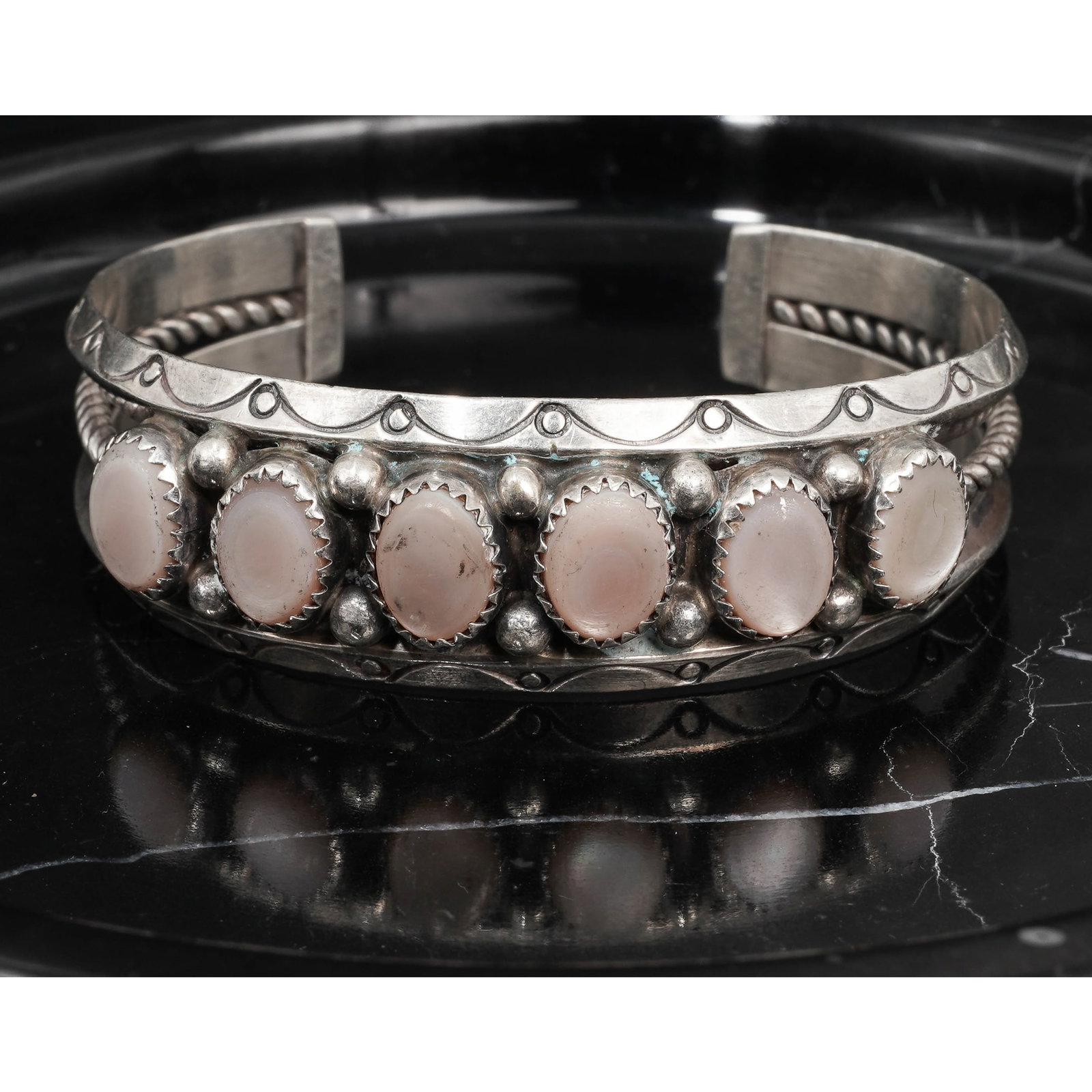 Vintage Sterling Silver & MOP Cuff Bracelet Signed: Vintage Sterling Silver & MOP Cuff Bracelet SignedCirca: 1950s-1960s, USASterling silver cuff bracelet constructed with six oval mother-of-pearl cabochons each measuring approximately 10 × 8mm.set in