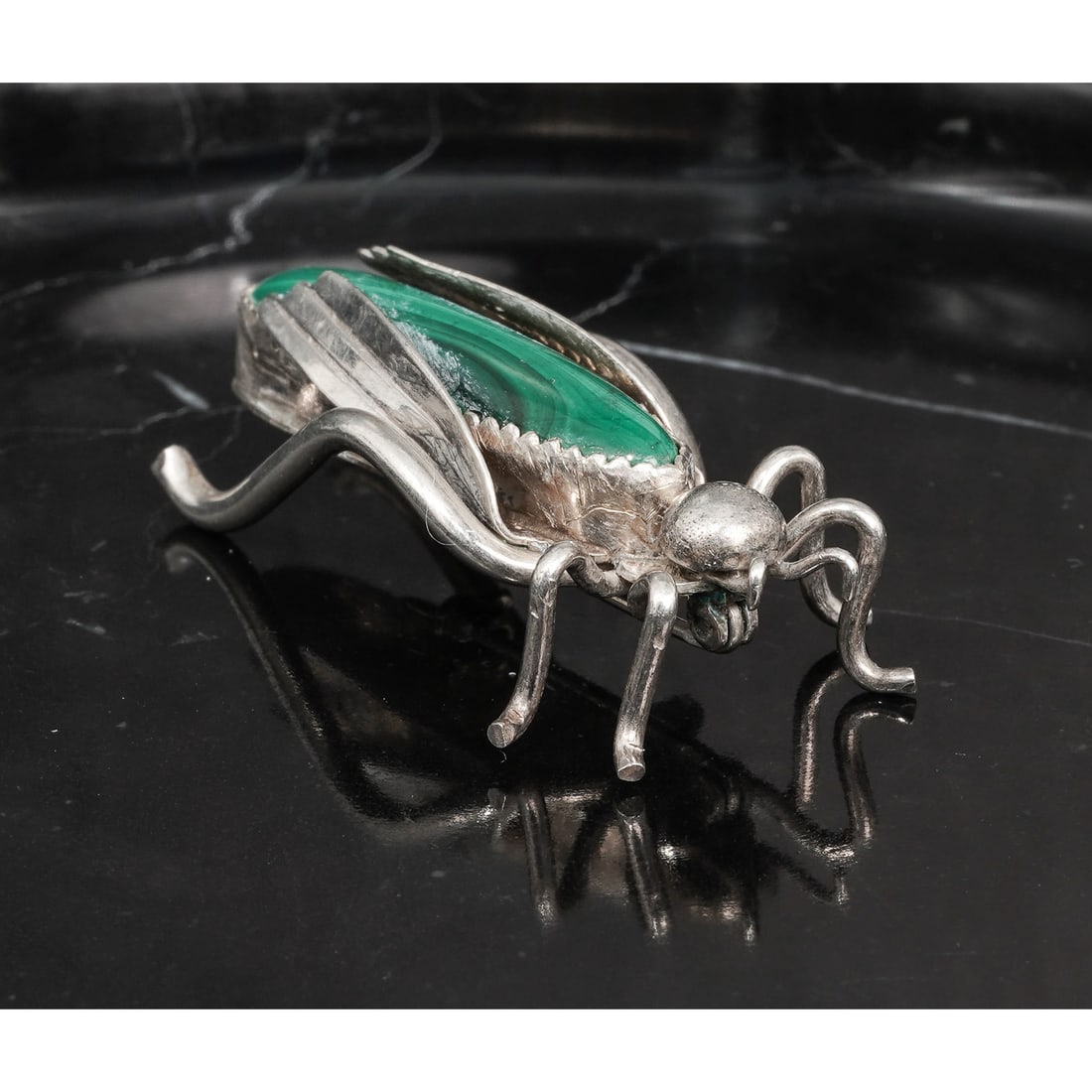 Vintage Navajo Sterling Silver & Malachite Insect Brooch: Vintage Navajo Sterling Silver & Malachite Insect BroochCirca 1970s-1980s, USAVintage Navajo sterling silver figural insect brooch centered by a long tapered malachite cabochon measuring approximately