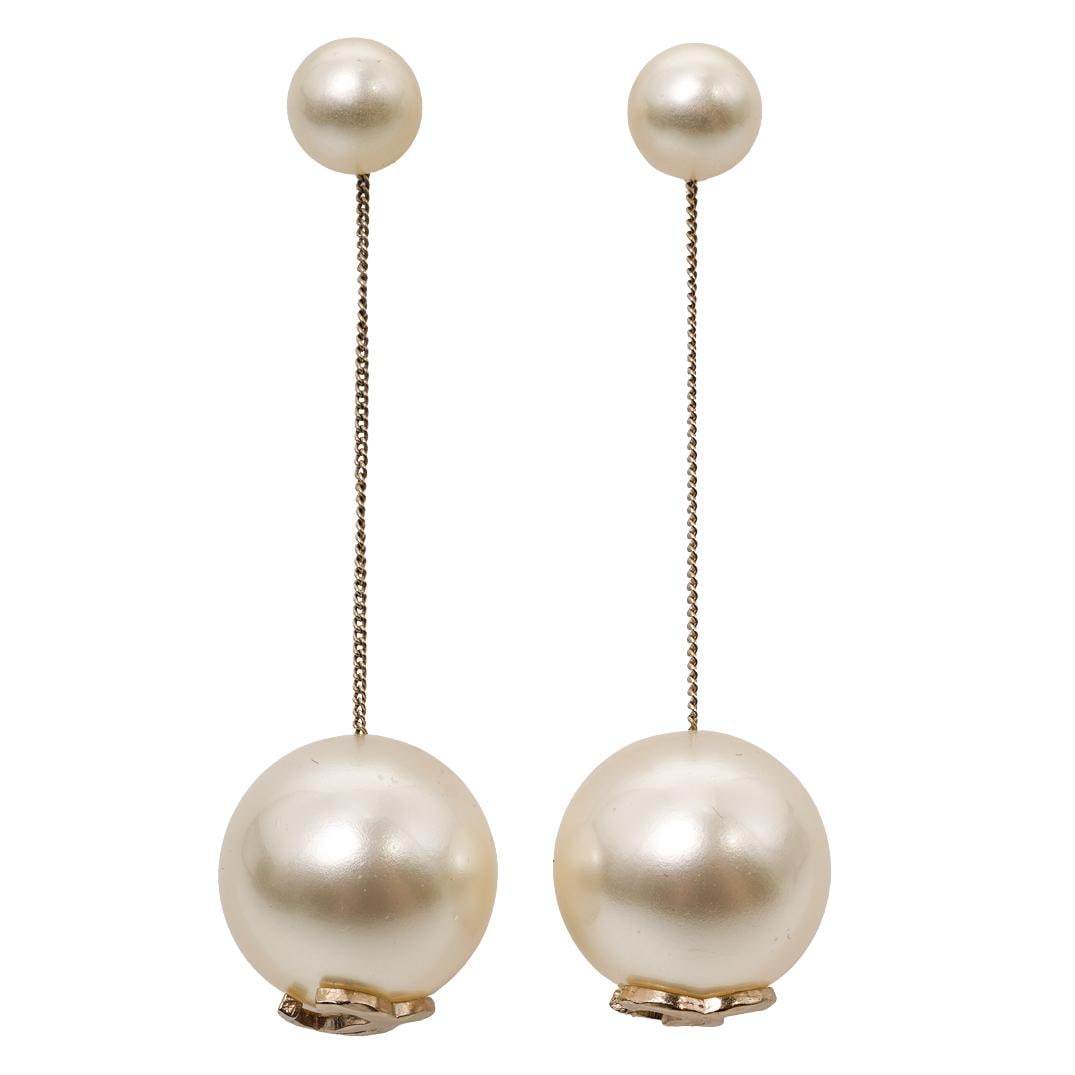 Chanel CC Logo Pearl Drop Earrings: Chanel CC Logo Pearl Drop EarringsCirca Late 20th Century, ItalianPair of Chanel CC logo pearl drop earrings. Each earring is designed with a large synthetic pearly-white spherical bead fitted with an