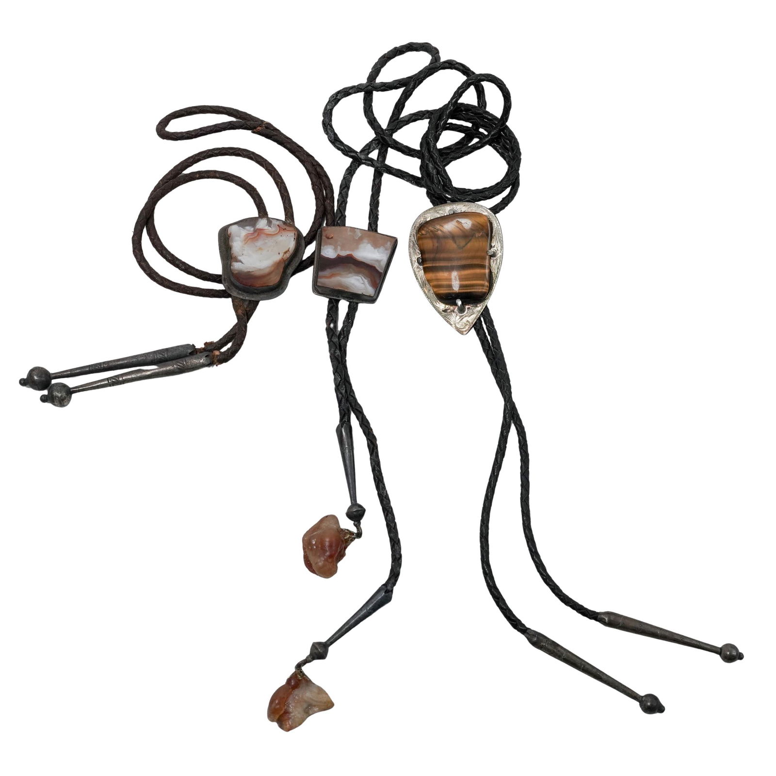 (3 Pc) Sterling Silver & Gemstone Bolo Ties: (3 Pc) Sterling Silver & Gemstone Bolo TiesLate 20th c., USA(1) Bolo tie featuring an engraved sterling silver teardrop slide set with a large tiger's eye stone on a black leather cord with sterling s