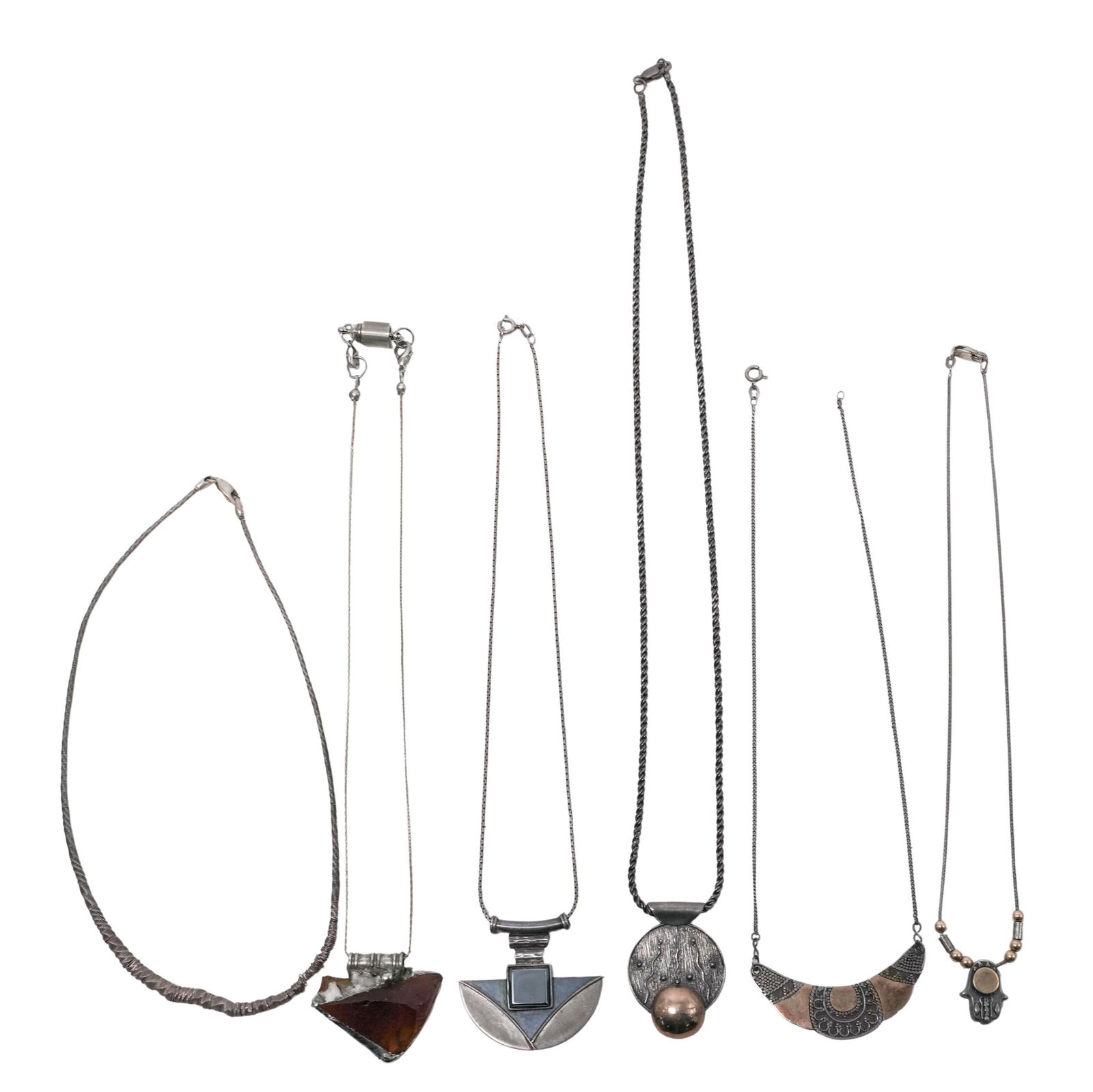 (6 Pc) Vintage Sterling Silver & Mixed Metal Art Necklaces: (6 Pc) Vintage Sterling Silver & Mixed Metal Art NecklacesMid to Late 20th c.(1) Fire agate and silver pendant on a silver tone chain.(1) Sterling silver and 10k gold Hamsa hand pendant with gold and
