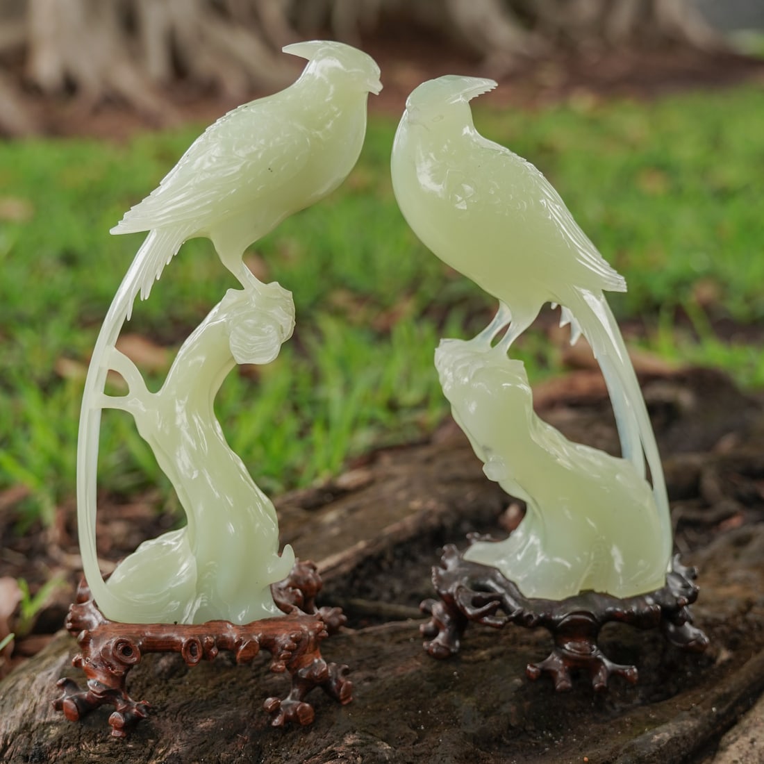 Pair Chinese Carved Serpentine Jade Birds: Pair Chinese Carved Serpentine Jade Birds20th century, ChineseA set of two Chinese hand-carved serpentine jade birds. Ornately carved wood stands.Provenance: From a private Palm Beach residence.H 7.62