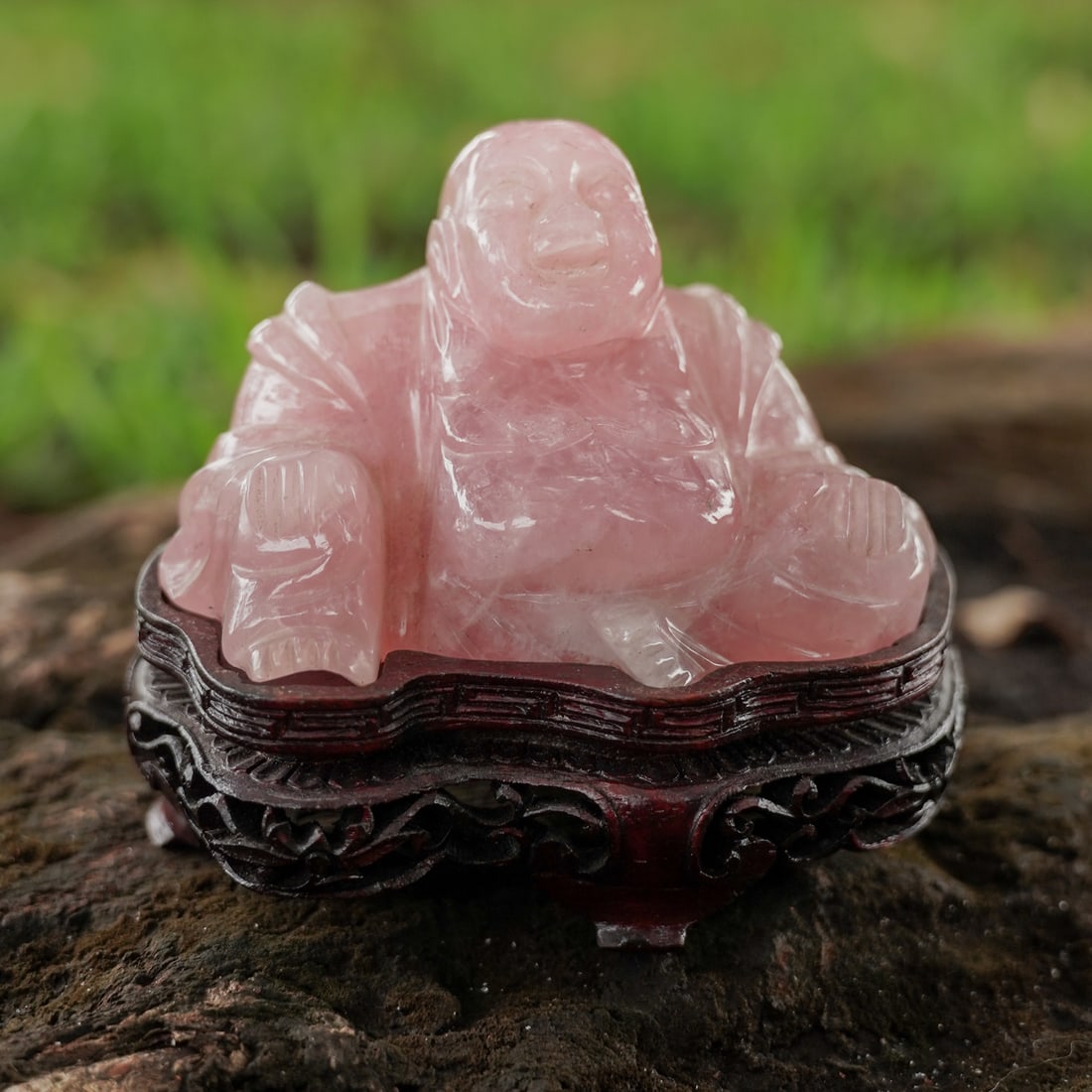 Chinese Carved Rose Quartz Laughing Buddha: Chinese Carved Rose Quartz Laughing Buddha20th century, ChineseA hand-carved Chinese jade laughing Buddha figurine on a wooden base.Provenance: From a private Palm Beach residence.H 2" x L 3.5" x W 2"