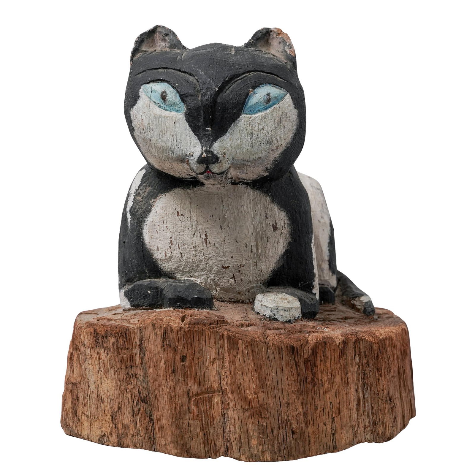 Vintage Folk Art Carved Cat Sculpture: Vintage Folk Art Carved Cat SculptureMid to late 20th century, AmericanA vintage folk art carved cat sculpture with hand-painted detail. The cat features a distinct black-and-white pattern and blue ey