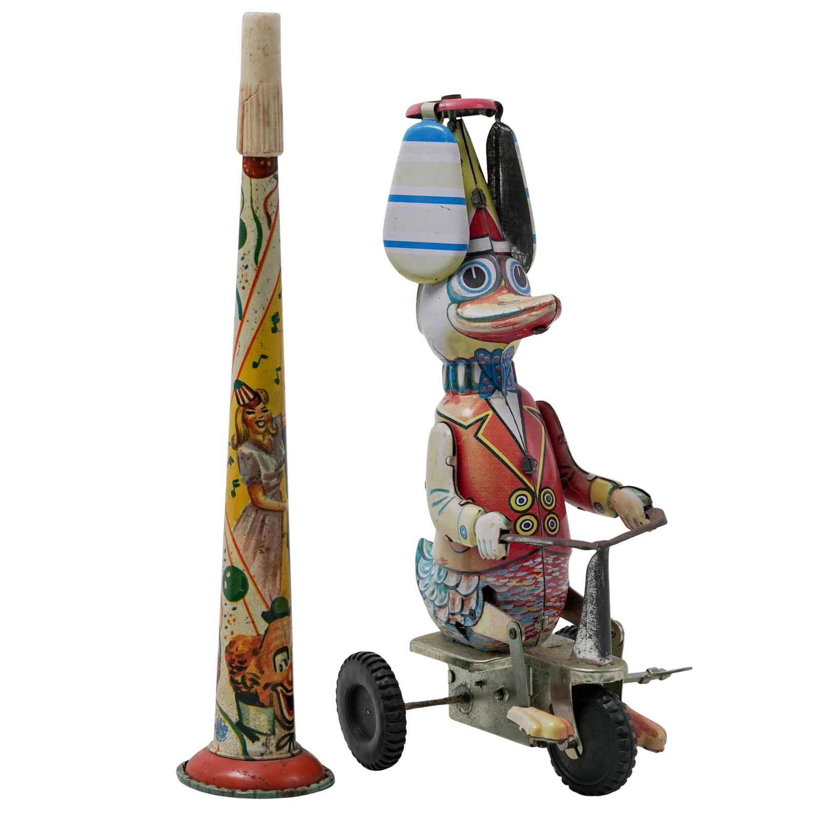 (2pc) Litho Party Horn Noisemaker & Tin Toy: (2pc) Litho Party Horn Noisemaker & Tin Toy20th century,The horn features colorful graphics of dancing couple and a clown. The duck when wound up, pedals the tricycle and a propeller on its hat spins.