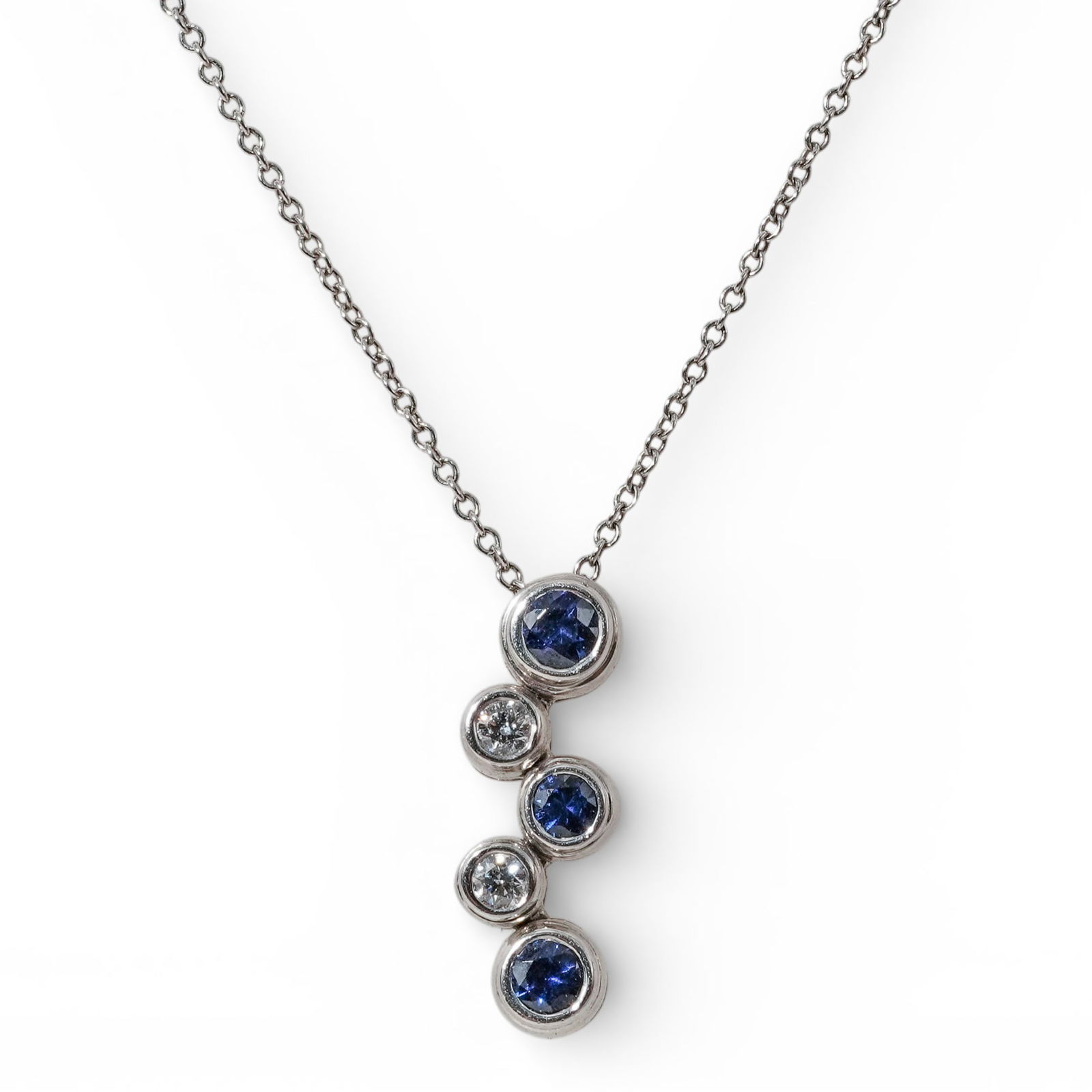 Tiffany & Co. Platinum Sapphire & Diamond Pendant Necklace: Tiffany & Co. Platinum Sapphire & Diamond Pendant Necklace 2003, USA Platinum pendant necklace designed with a vertical, articulated cluster of bezel-set round sapphires alternating with round