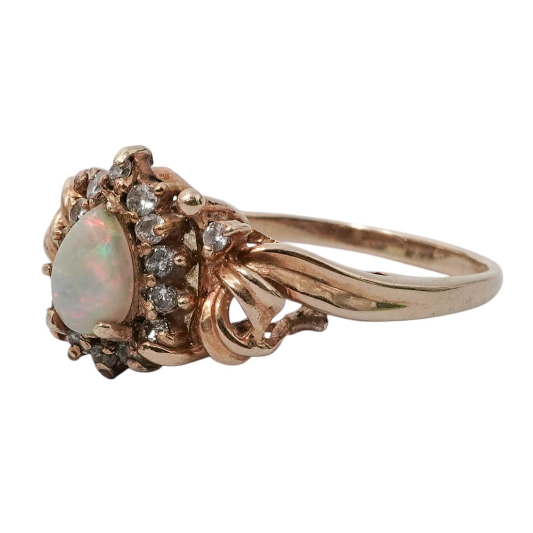 Vintage 14K Gold, Opal & Diamond Ring: Vintage 14K Gold, Opal & Diamond RingMid to Late 20th c.14 karat yellow gold ring featuring a pear-shaped opal surrounded by a halo of small round diamonds and twisted gold ribbon detailing. It is sta