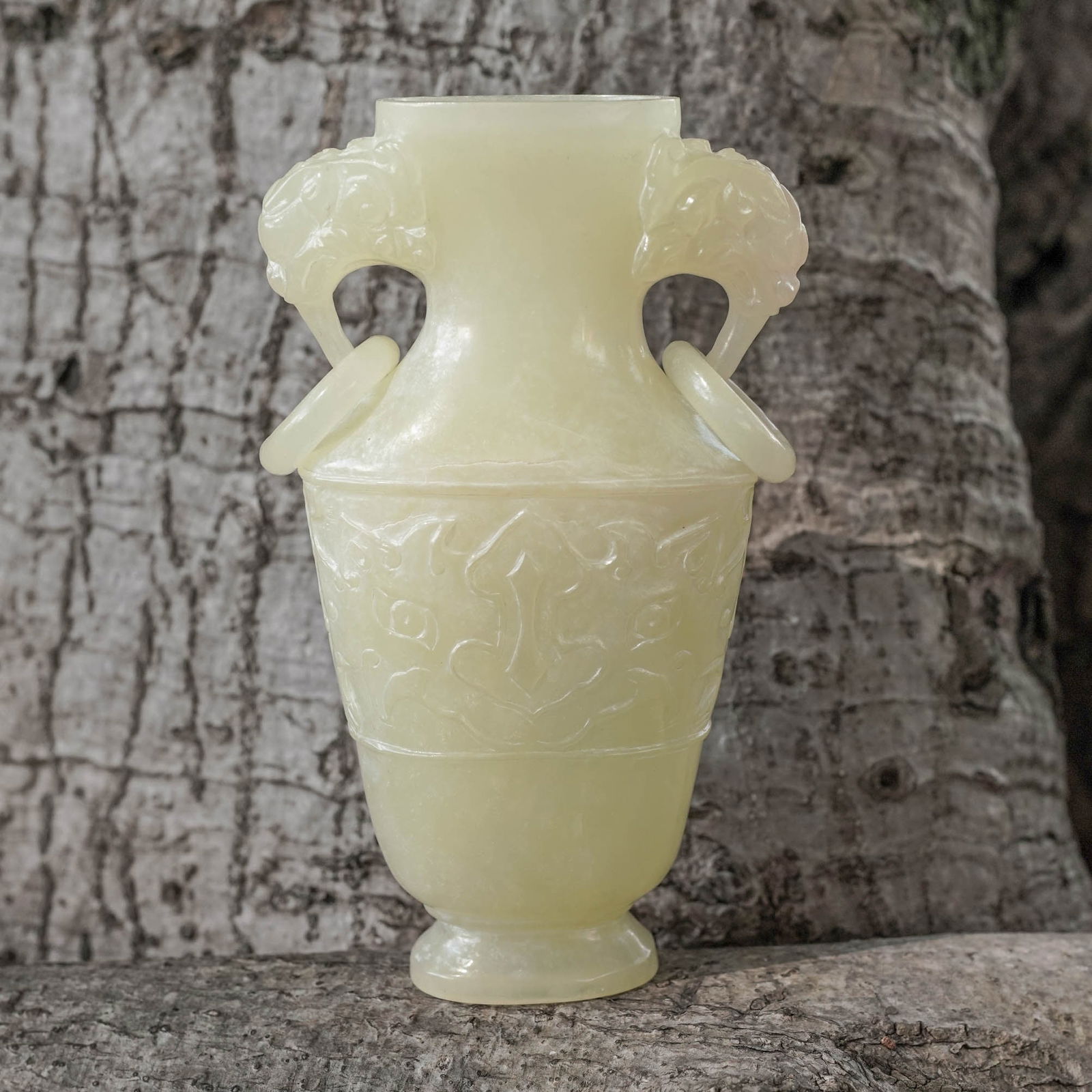 Chinese Qing Dynasty Jade Foo Dog Urn: Chinese Qing Dynasty Jade Foo Dog UrnLate 19th-Early 20th c., ChinaAntique Chinese hand-carved jade unlidded urn featuring a carved Foo Dog face on either side and intricate handled depicting the head