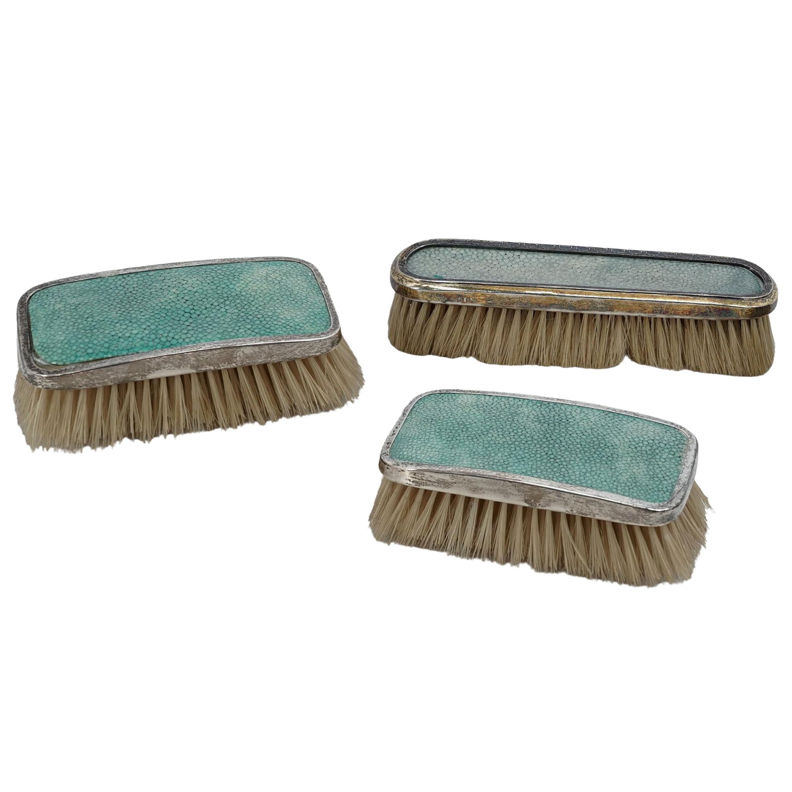 (3pc) Antique English Sterling Silver & Shagreen Handle Brush Group: (3pc) Antique English Sterling Silver & Shagreen Handle Brush GroupEarly 20th Cent.,EnglishA group of three sterling silver and shagreen-handled brushes including one brush marked "C&R", "R", lion pas