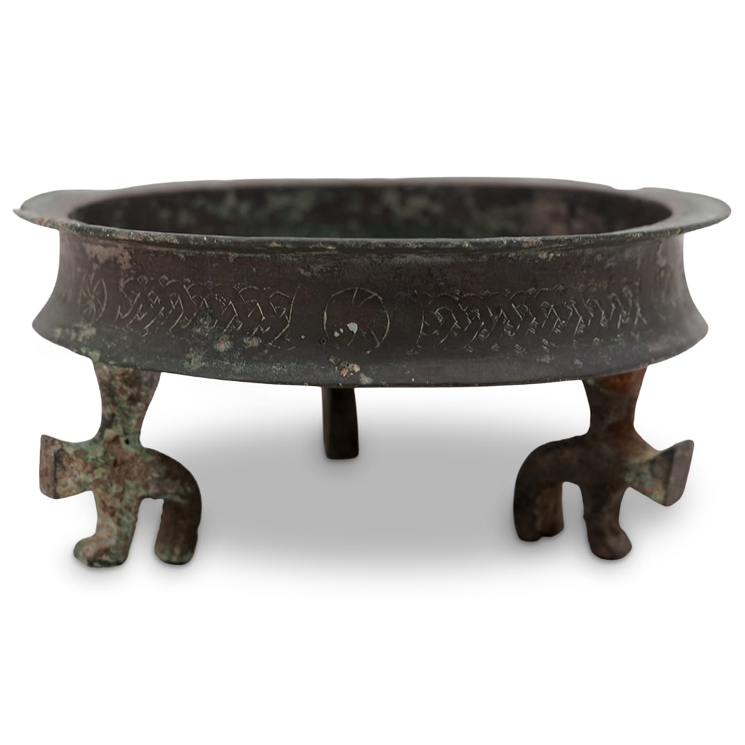 Seljuk Khorasan Ornate Bronze Footed Dish: Seljuk Khorasan Ornate Bronze Footed Dish 12th c., Iran Medieval-era Persian tray/bowl with three zoomorphic feet, a flat base, slightly concave sides, and a flared rim. The interior is engraved with