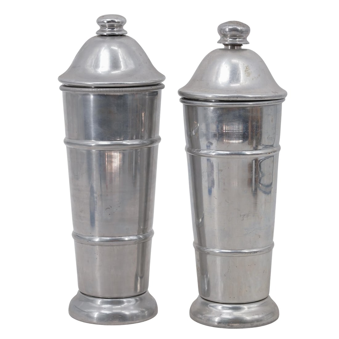 (2 Pc) Kraftware Coldseal Aluminum Cocktail Shakers: (2 Pc) Kraftware Coldseal Aluminum Cocktail Shakersc. 1946Art Deco–style aluminum cocktail shaker with a design that tapers from broader shoulders and a bell-shaped top to a round base, with raised