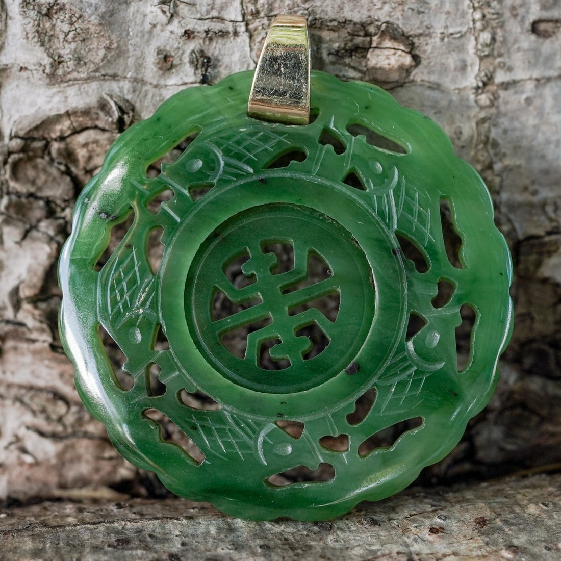 Chinese Gold & Carved Jade Disc Pendant: Chinese Gold & Carved Jade Disc Pendant Late 20th c., China Chinese hand-carved reticulated jade pendant featuring a rotating shou symbol in the middle encircled by engraved fish. The bail is gold