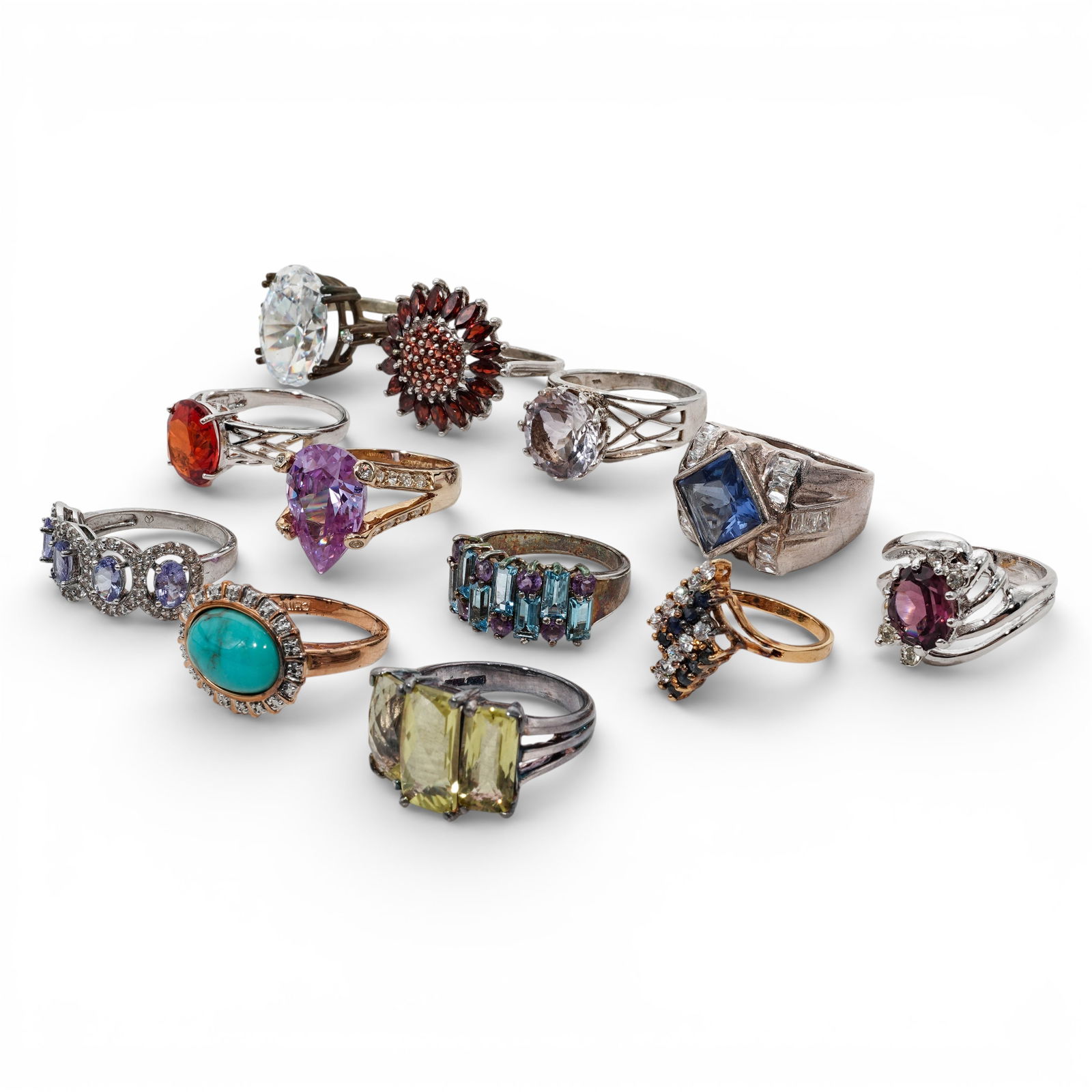 (12 Pcs) Sterling Silver & Synthetic Stone Ring Collection: (12 Pcs) Sterling Silver & Synthetic Stone Ring Collection Late 20th Century A curated collection of 12 sterling silver rings presenting a broad mix of colors, stone shapes, and design styles. The