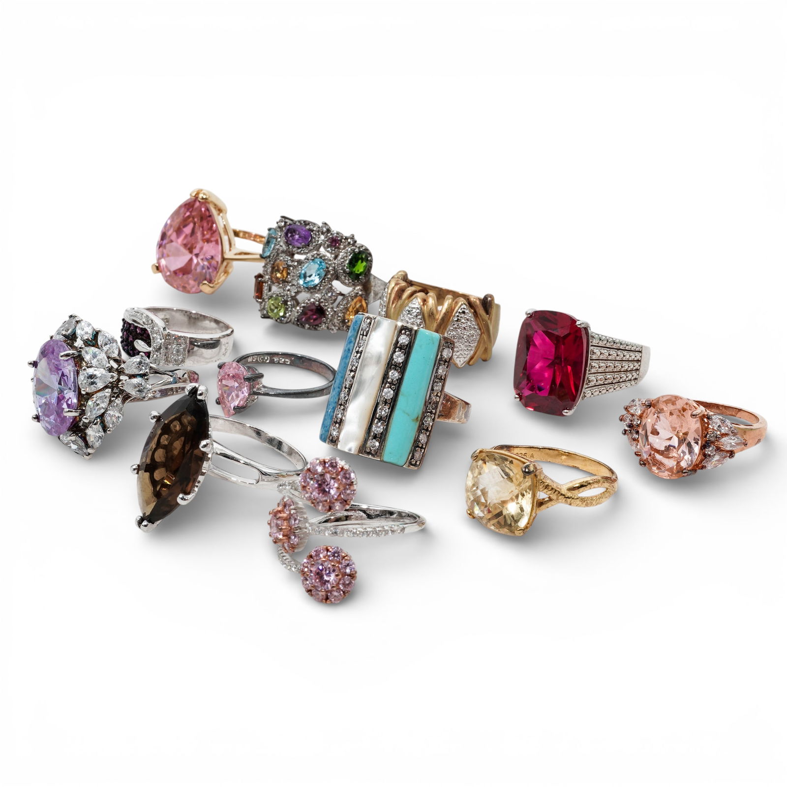 (12 Pcs) Sterling Silver & Synthetic Stone Ring Collection: (12 Pcs) Sterling Silver & Synthetic Stone Ring Collection Late 20th Century A curated collection of 12 sterling silver rings presenting a broad mix of colors, stone shapes, and design styles. The