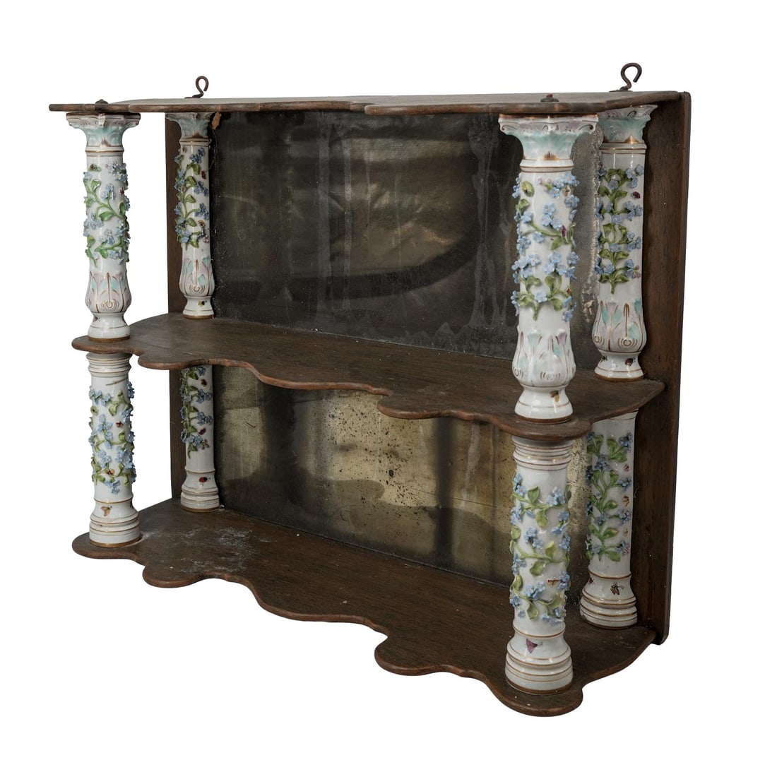 Antique German Porcelain & Wooden Wall Shelf: Antique German Porcelain & Wooden Wall Shelf Late 19th-early 20th century, German An antique German wooden hanging wall shelf with ornate, floral sculpted porcelain pillars and mercury mirror panels.