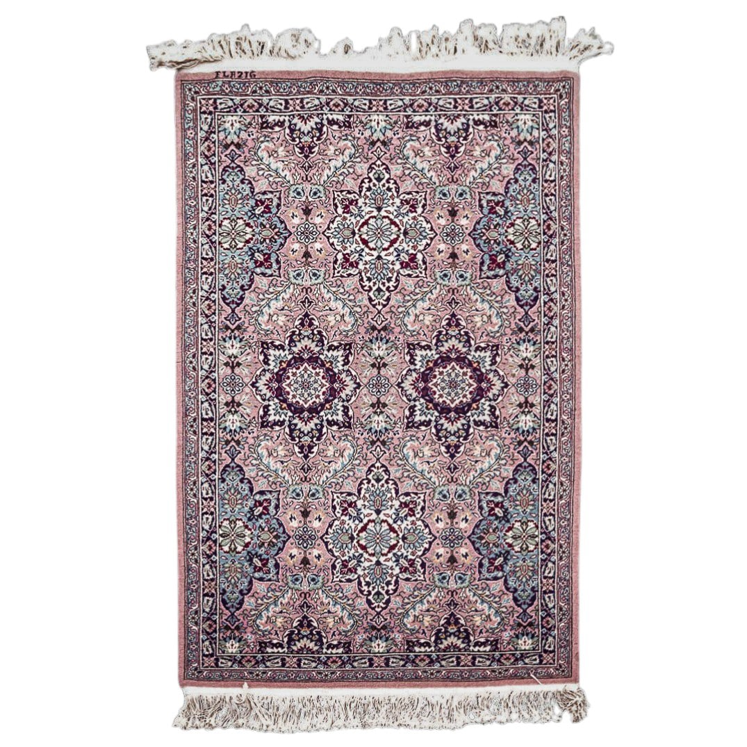 Signed Turkish Wool Floral Rug: Signed Turkish Wool Floral Rug 20th century A Turkish rug signed "Elazig" in one corner. Features a pink background with all-over Turkish eight-point star motifs, symbolizing happiness and fertility