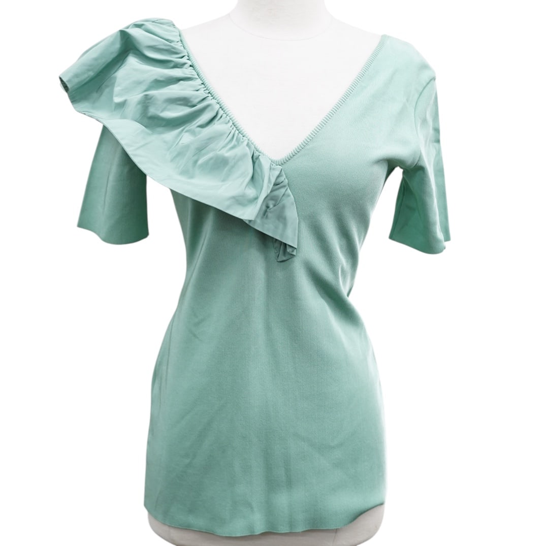 Givenchy Turquoise Blouse: Givenchy Turquoise Blouse21st century, FrenchGivenchy turquoise blouse, fitted shape with short sleeve and ruffle detail. Garment tag marked "Givenchy Paris" "M" "BW60SZ4Z8U".H 26.25" x W (shoulders)