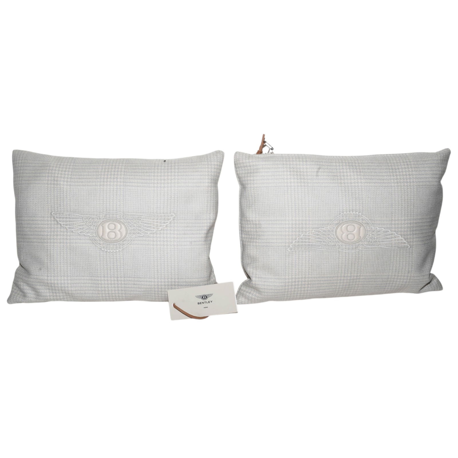 Pair Bentley Blue Tweed Pillows: Pair Bentley Blue Tweed Pillows21st century, ItalianA pair of Bentley blue tweed pillows with white leather "B" logo and embroidered wings. Pillows have silver tone metal "Bentley" plaque in upper cor