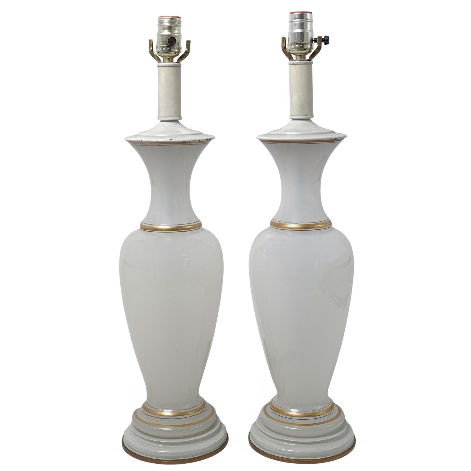 Pair Of French Opaline Glass Table Lamps: Pair Of French Opaline Glass Table Lampsc. 1960s, FranceTwo vintage milky-white opaline glass lamps featuring an elongated baluster form with a flared neck and gold-leaf bands around the rim, neck, an