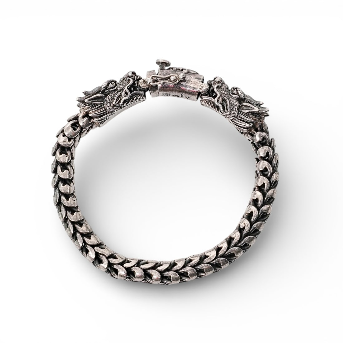 Gervida Sterling Silver Double Dragon Bracelet: Gervida Sterling Silver Double Dragon BraceletEarly 21st Century, Southeast AsianHeavy sterling silver bracelet formed as a scaled link body terminating in opposed dragon heads, joined by a concealed