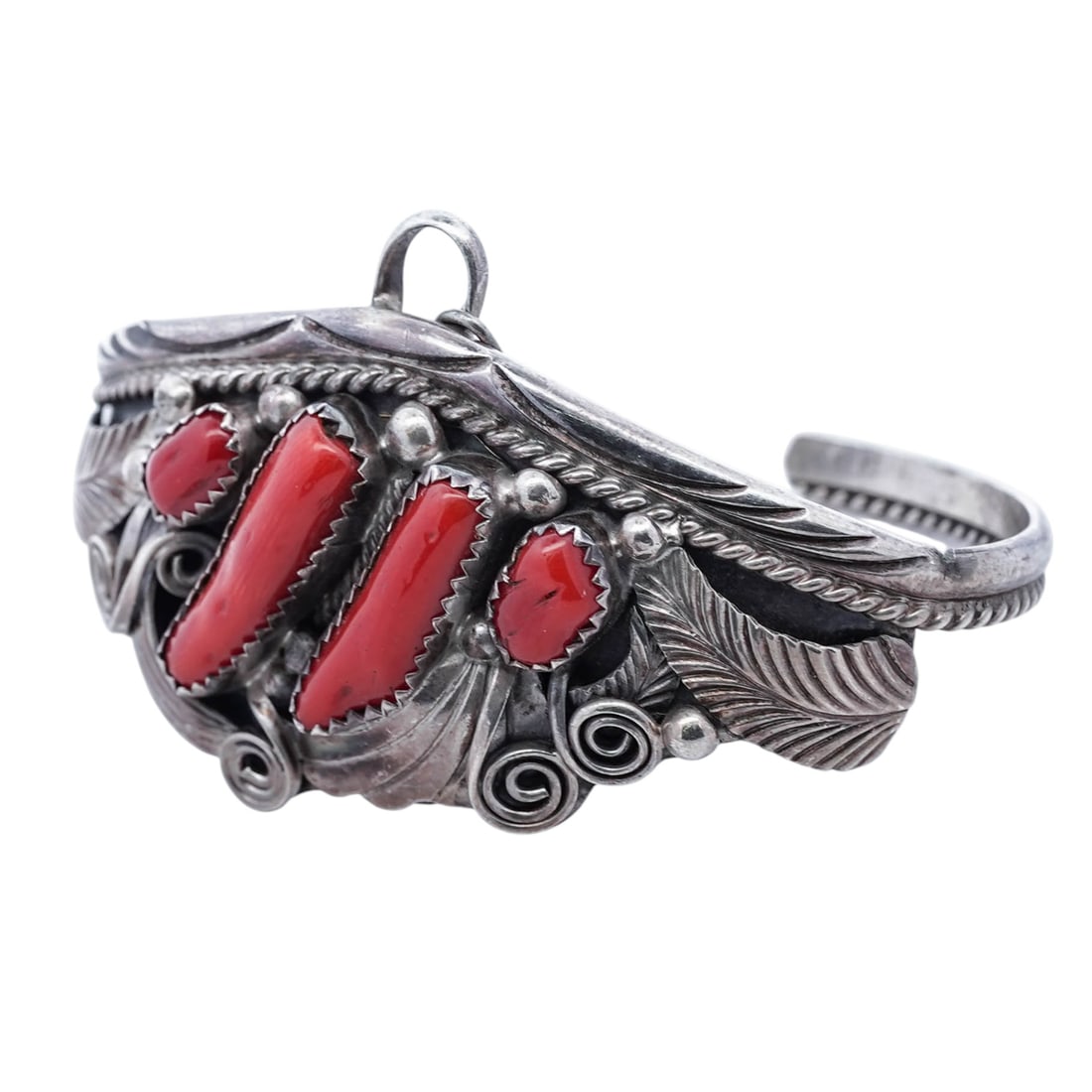 J. Morris Vintage Navajo Sterling Silver & Coral Cuff Bracelet: J. Morris Vintage Navajo Sterling Silver & Coral Cuff Bracelet 1960s–1970s, American Vintage Navajo sterling silver cuff bracelet set with a graduated arrangement of five red coral cabochons, the