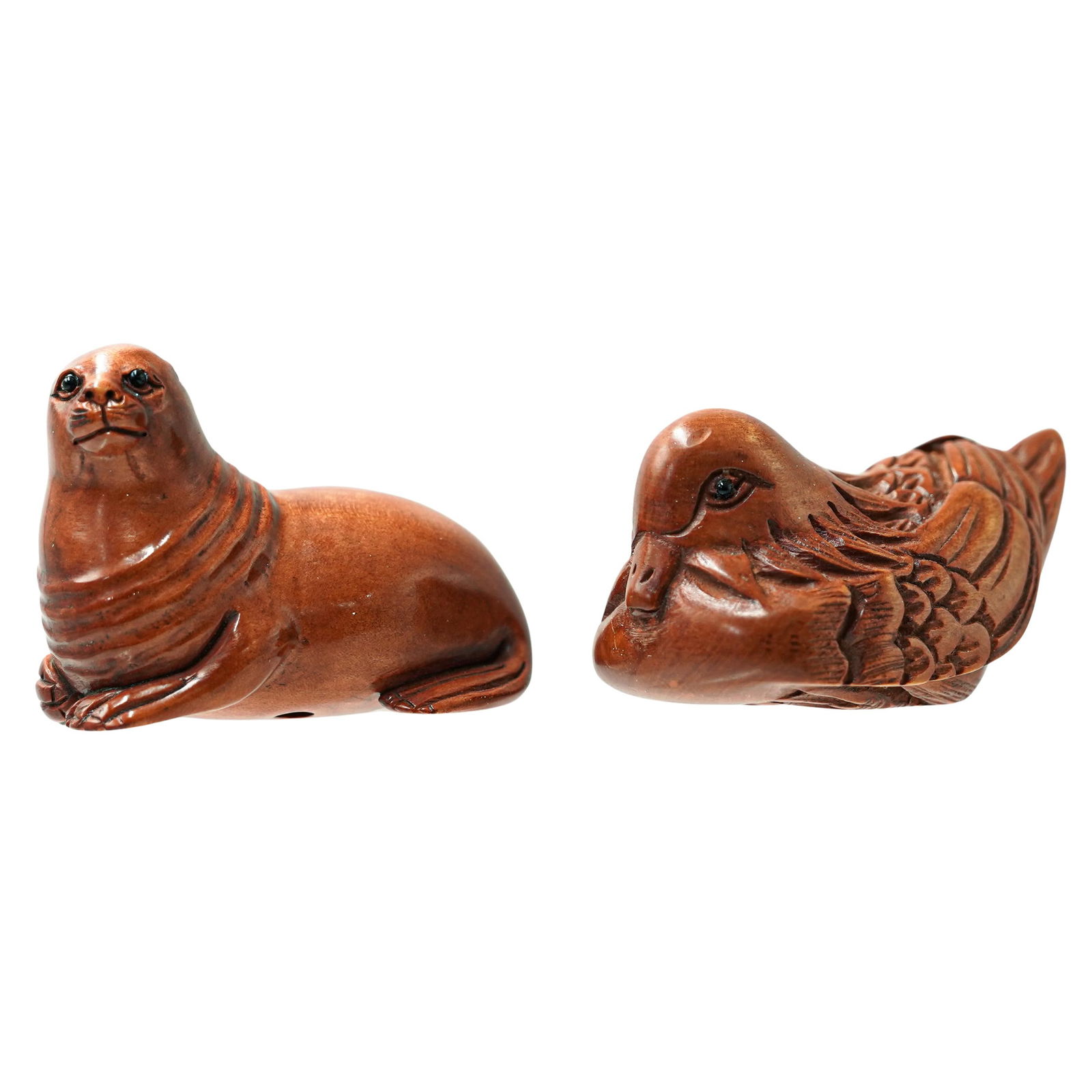 (2 Pc) Japanese Boxwood Animal Netsuke Figurines: (2 Pc) Japanese Boxwood Animal Netsuke Figurines20th c., JapanTwo hand-carved boxwood netsuke figurines depicting a duck and a seal/sea lion. Both are signed by the artists on the underside.H: 1.25" W