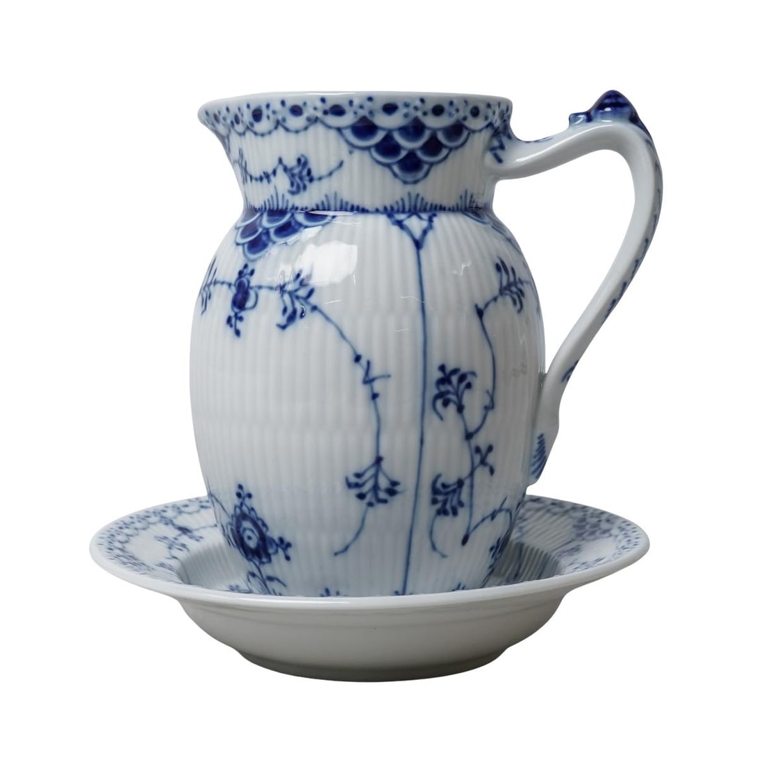 (2pc) Royal Copenhagen Blue Fluted Half Lace Porcelain Pitcher & Saucer: (2pc) Royal Copenhagen Blue Fluted Half Lace Porcelain Pitcher & SaucerEarly to Mid 20th century, DanishTwo pieces of Royal Copenhagen porcelain, including one Blue Fluted Half Lace pitcher, known for