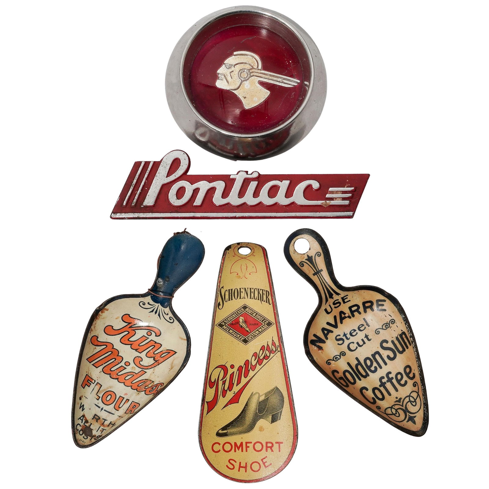 (5 pcs) Adware Tin Litho Badges, Scoops, Shoe Horn: (5 pcs) Adware Tin Litho Badges, Scoops, Shoe HornEarly 20th century, AmericanA set of five early 20th century tin litho and metal adware badges, scoops, and a shoe horn.(1) Schoenecker "Princess" sma
