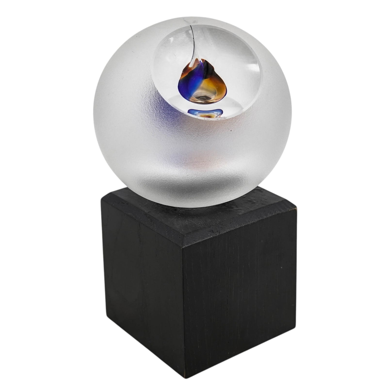 Large Frosted Glass Sculpture on Wood Base: Large Frosted Glass Sculpture on Wood Base 20th Century Large round art glass paperweight with a frosted, textured exterior surface, enclosing an internal abstract teardrop design in blue and gold