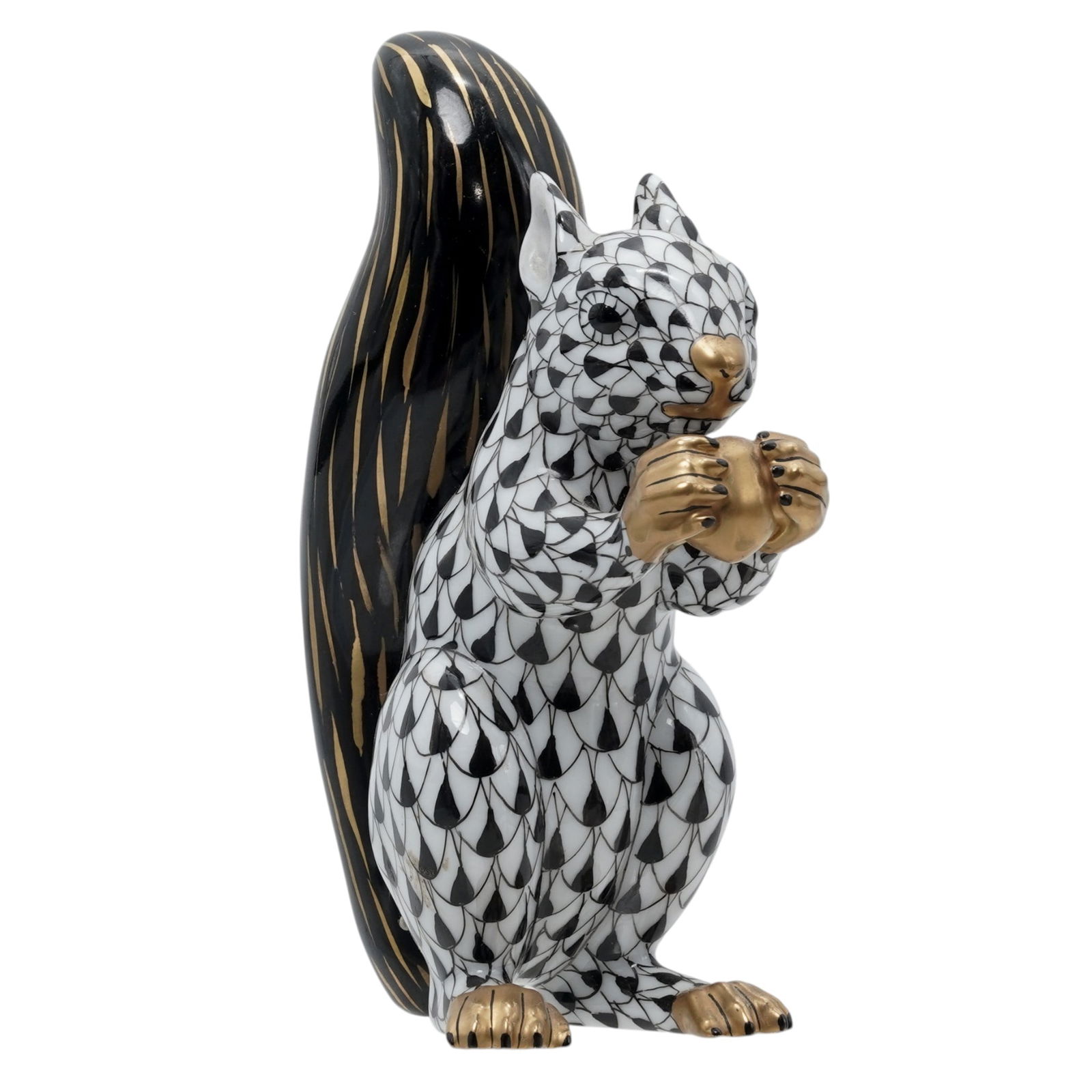 Herend Porcelain "Squirrel" Black Fishnet Figurine: Herend Porcelain "Squirrel" Black Fishnet Figurine20th century, HungarianHerend porcelain figurine depicting a squirrel with an acorn in the black fishnet pattern with 24k gold accents. Marked with He
