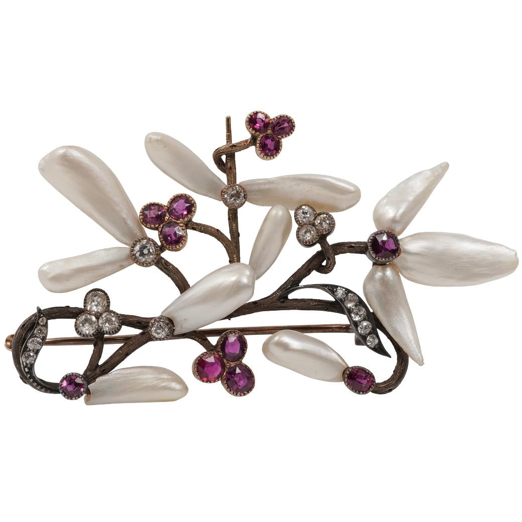Antique Gilt Silver Pearl Diamond & Garnet Floral Brooch: Antique Gilt Silver Pearl Diamond & Garnet Floral BroochLate 19th–early 20th centuryAntique floral brooch composed of branching gilt silver stems terminating in articulated flower and bud motifs. Th