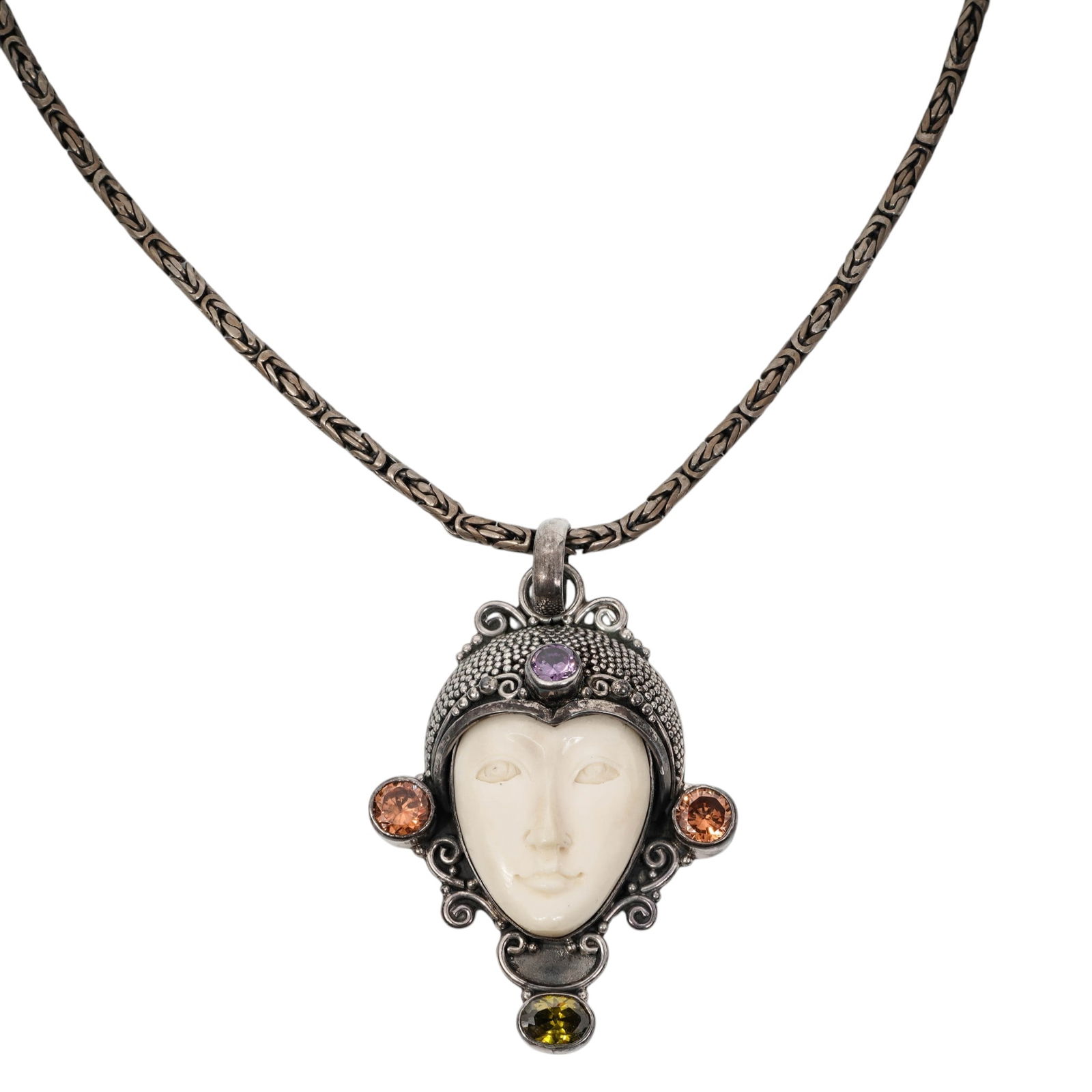 Sajen Style Sterling Silver Carved Face & Gemstone Pendant Necklace: Sajen Style Sterling Silver Carved Face & Gemstone Pendant Necklace 1990s-2000s, Indoneisa Sterling silver pendant necklace centered by a carved bone face plaque within a granulated and scrollwork