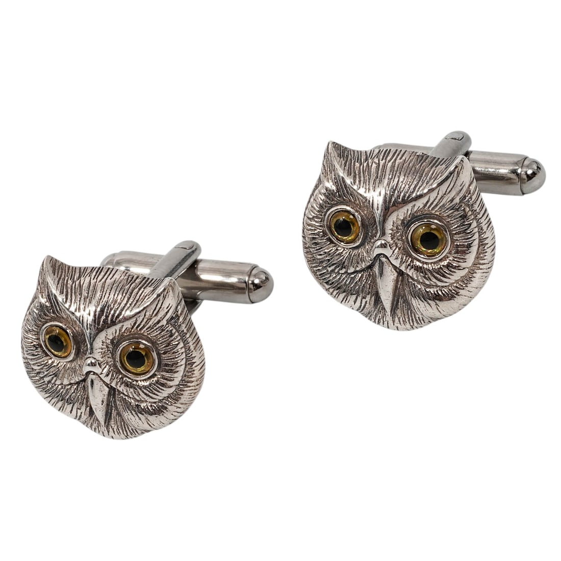 Sterling Silver Owl Head Cufflinks: Sterling Silver Owl Head Cufflinks Late 20th Century Pair of sterling silver cufflinks formed as detailed owl heads with textured feather modeling and round yellow inset eyes. Bullet-back toggle