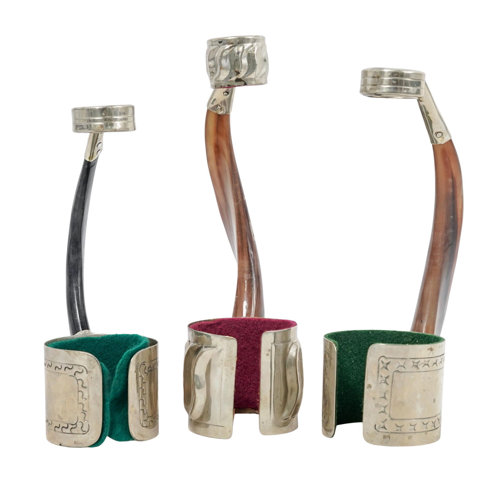 (3pc) Alpaca Silver & Horn Wine Caddies: (3pc) Alpaca Silver & Horn Wine Caddies 20th Cent.,Argentinian Alpaca silver and goat horn wine bottle holders, featuring a curved horn as a balanced handle, while the metal "cuffs" hold the base and