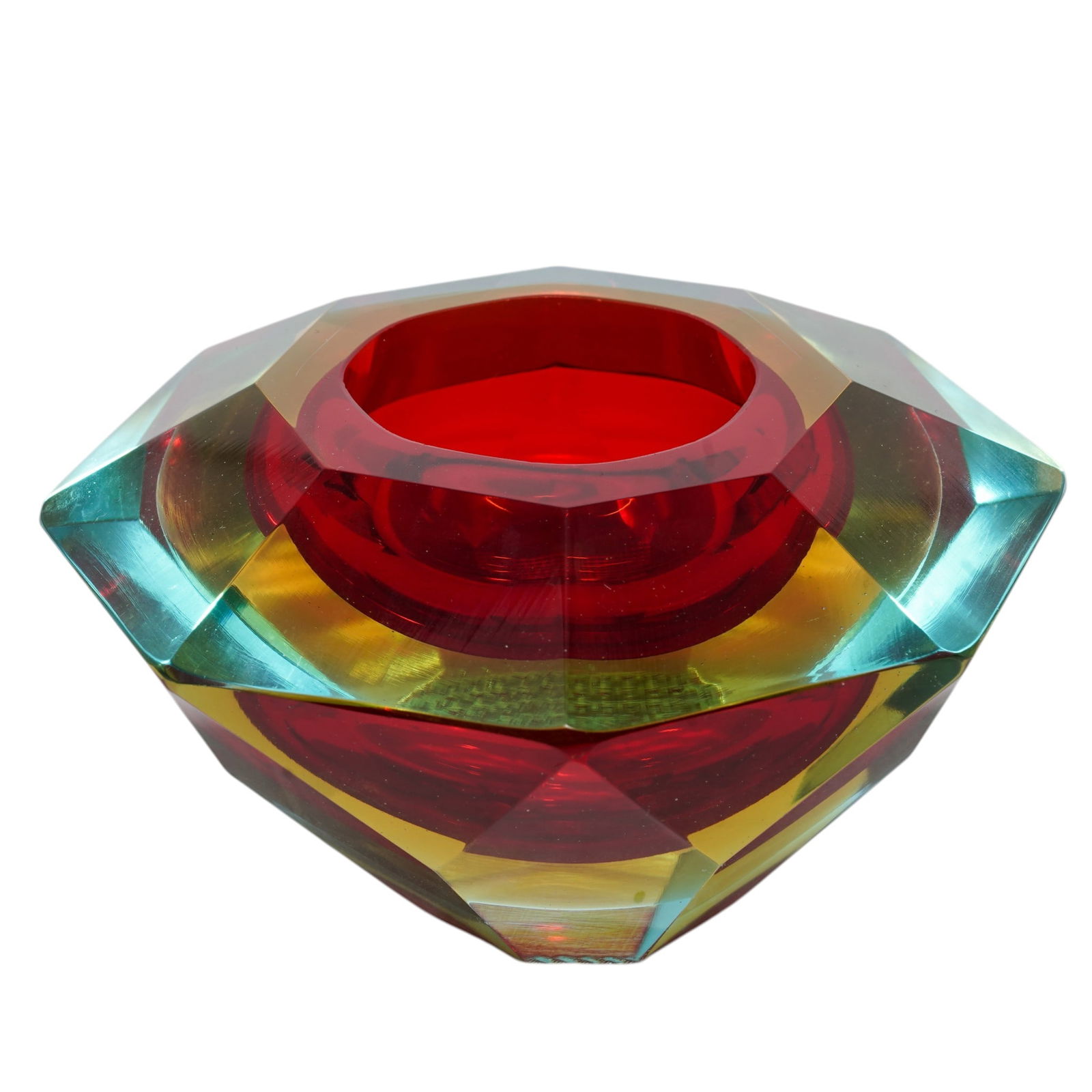 Faceted Multicolor Art Glass Votive Holder: Faceted Multicolor Art Glass Votive Holder20th CenturyFaceted art glass votive holder with an eight-sided exterior, executed in layered aqua blue, golden yellow, and fire red glass. Precision-cut and