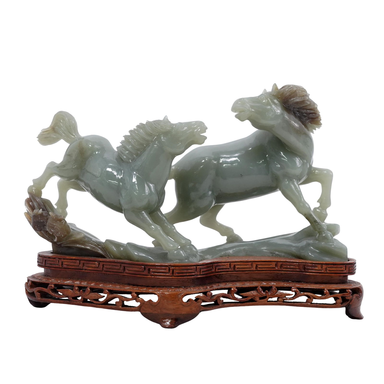 Chinese Carved Jade Galloping Horses Sculpture: Chinese Carved Jade Galloping Horses Sculpture 20th century, Chinese Chinese hand-carved jade statue depicting two galloping horses. It is mounted to a fitted carved wood base. H: 6.5" W: 3.25" L: 8"