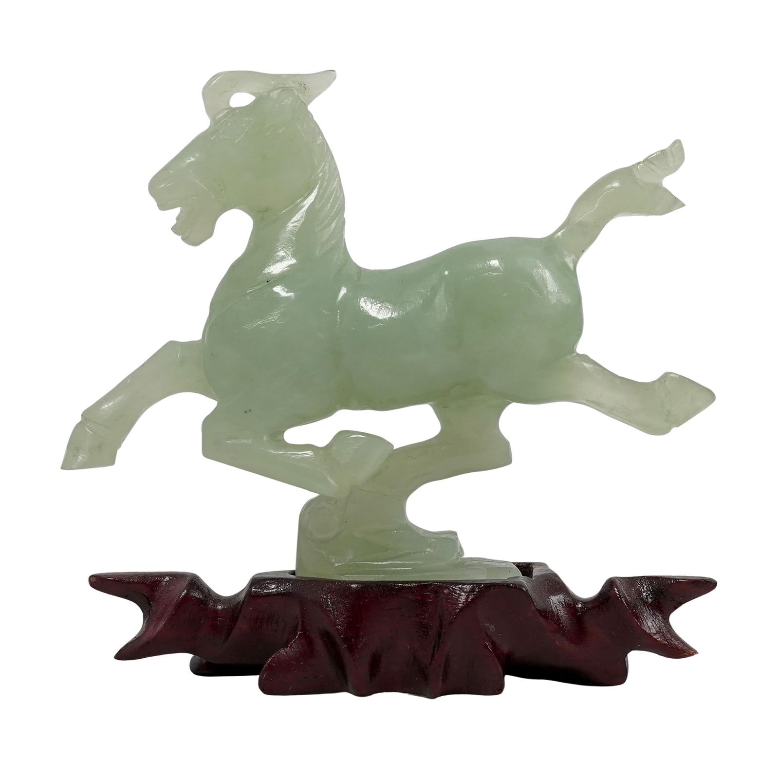 Chinese Carved Serpentine Jade Horse Sculpture: Chinese Carved Serpentine Jade Horse Sculpture20th century, ChinaIt is carved from light green jade, a material highly valued in Chinese art. The horse displays a flowing mane and tail, characteristic