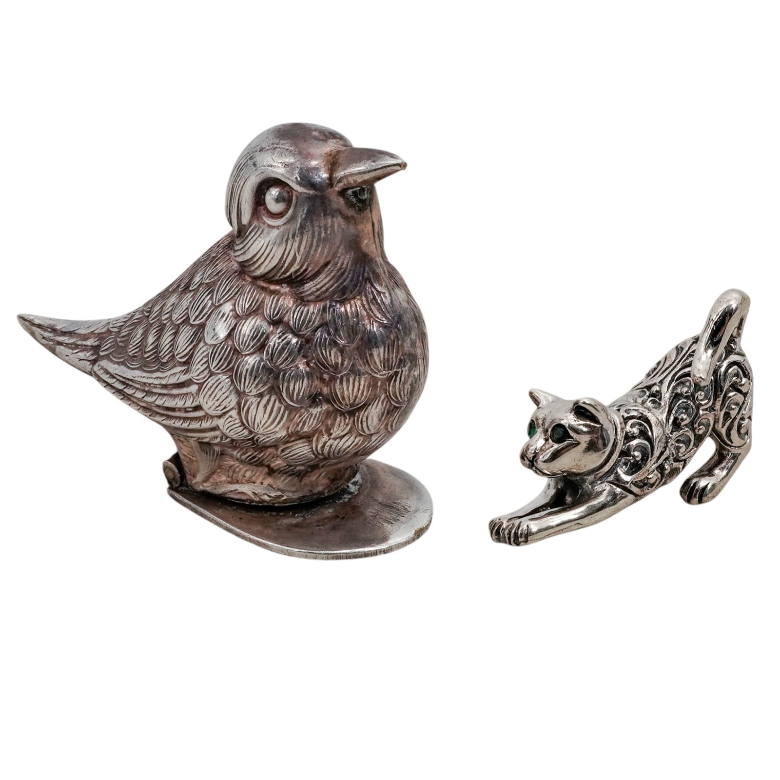 (2 pcs) Sterling Silver Cat and Bird Figurine: (2 pcs) Sterling Silver Cat and Bird Figurine 20th century (1) Sterling silver cat figurine/pendant with green cut stone eye insets. Marked on bottom "sterling". Total weight: 6 grams. (1) Silver