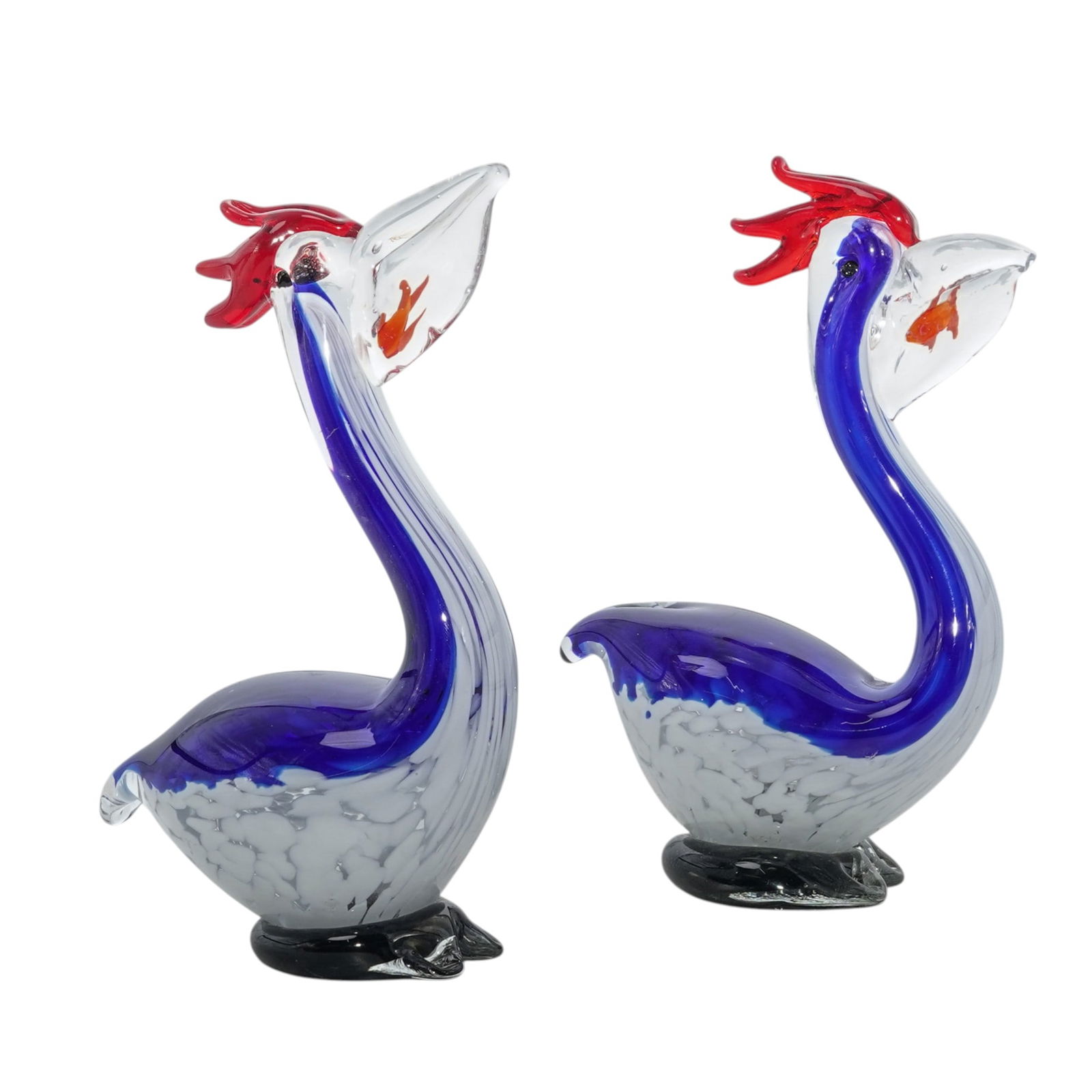 Pair Of Murano Pelican Art Glass Figures: Pair Of Murano Pelican Art Glass Figures 20th century, Italian (2 Pc) A Pair of Murano "Pelican" art glass figures. Designed with sommerso Murano glassmaking technique and an orange small fish inside