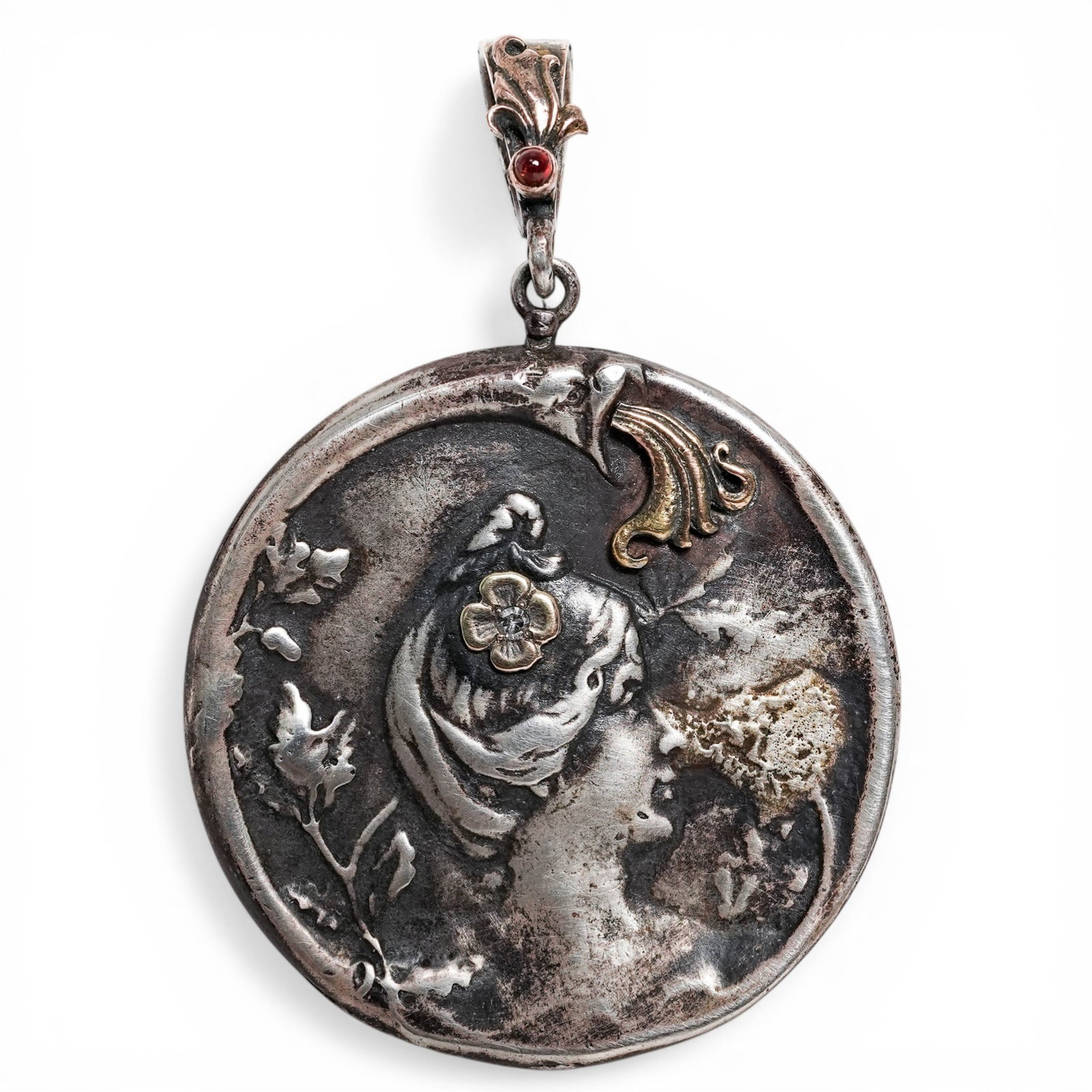 Russian Faberge Era Silver & 14k Gold Art Nouveau Pendant: Russian Faberge Era Silver & 14k Gold Art Nouveau Pendant20th Century, RussianCircular silver pendant cast in Art Nouveau style, depicting a female profile with flowing hair amid foliate elements. The
